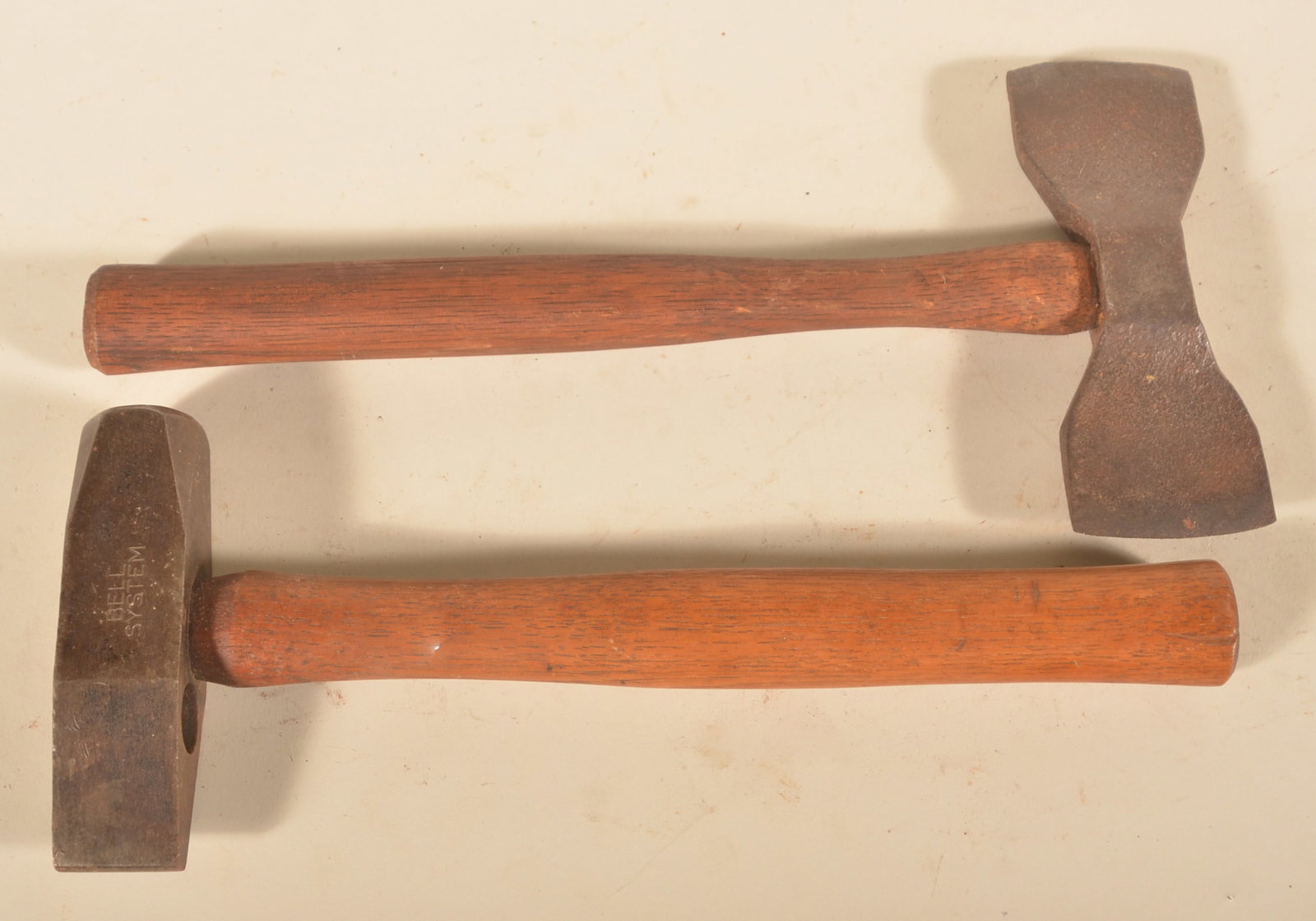 Small Double Bit Axe & Bell System Sledgehammer: Small double bit hand tool with a bowtie appearance. Hammer marked "Bell System". Bell system, 14 1/2"L