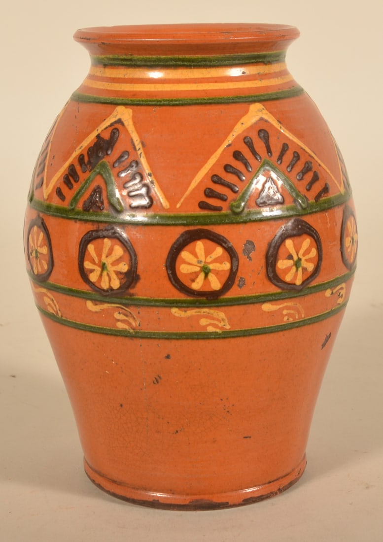 Slip-Decorated Greg Shooner Redware Jar: Slightly bulbous jar with crisp wagon wheel and geometric shape slip decoration. Signed and dated 1997. 9"H