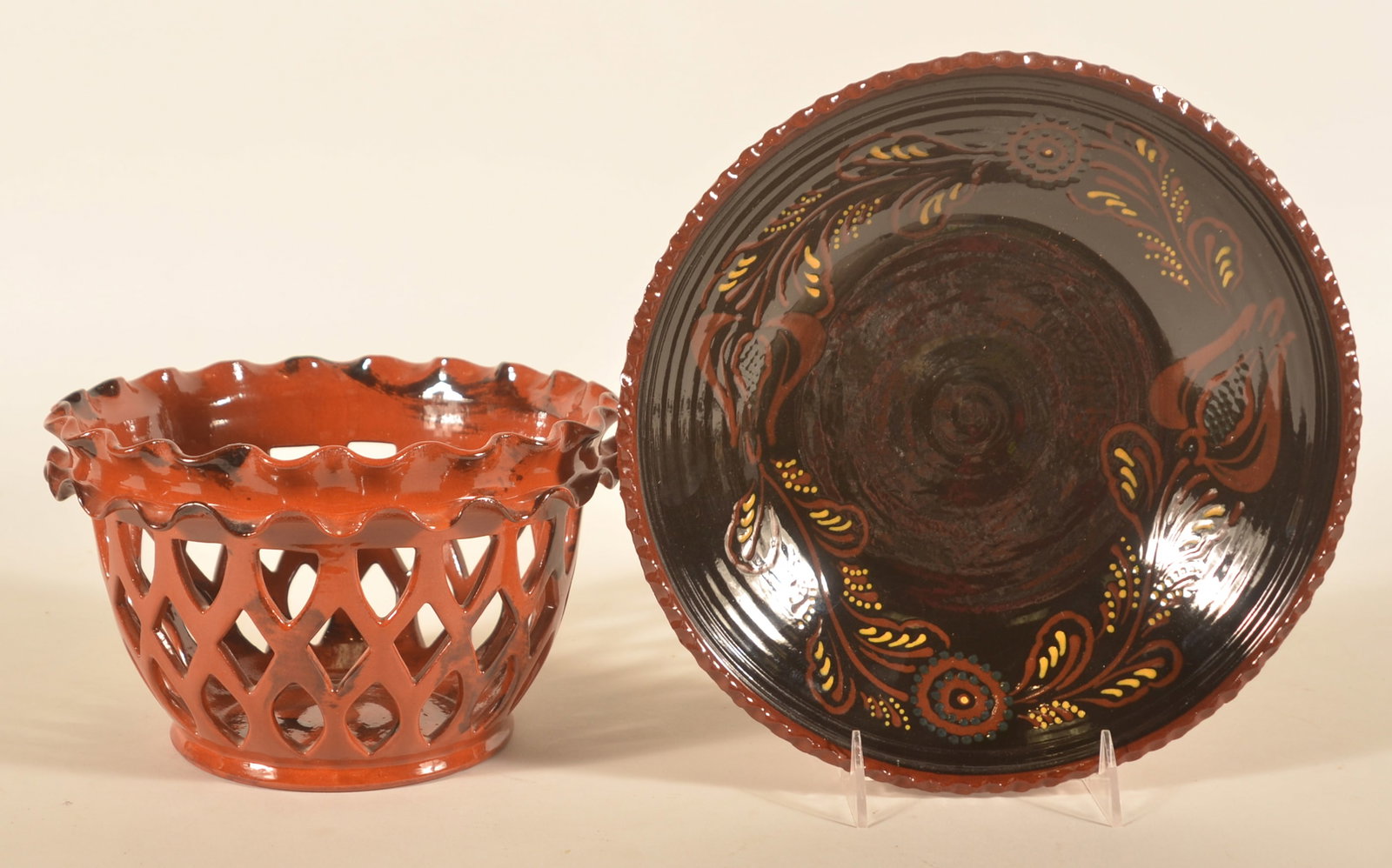 Breininger Openwork Basket & Foltz Redware Bowl: Very pretty openwork redware bowl with tobacco spit decoration signed and dated 1986 on bottom. Dark glaze redware bowl with tulip decoration signed by Ned Foltz and dated 2001. Openwork basket, 5 1/2