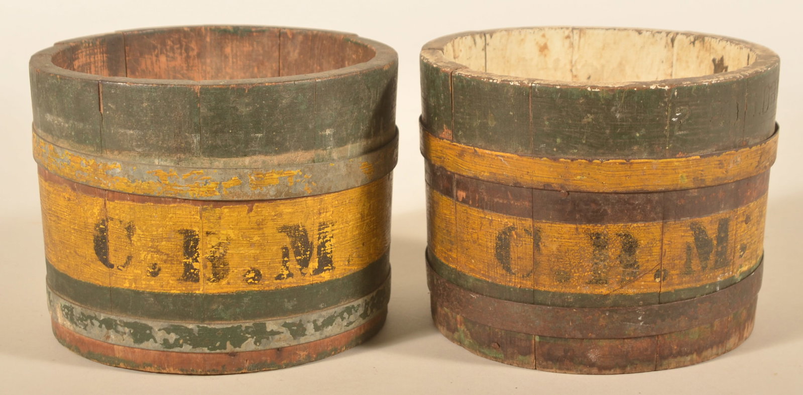 Pair of Great Paint-Decorated Wood Dry Measures: Each stamped "2 qts Dry". The paint is original and is a great dry mustard and green with excellent wear and patina. Matching initials "C.B.M." on each. Metal bands. 5 1/2"H x 7"D
