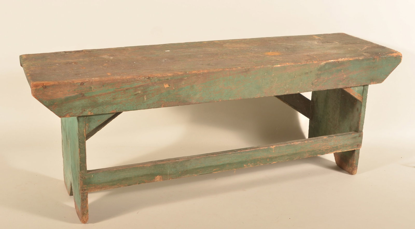 Small Painted Lancaster, PA Porch Bench: Late-19th-century pine and round nail porch bench in a blue/green paint with great dry surface. A nice stretcher board across the front and the original supports are in the back. Boot jack cut-outs on