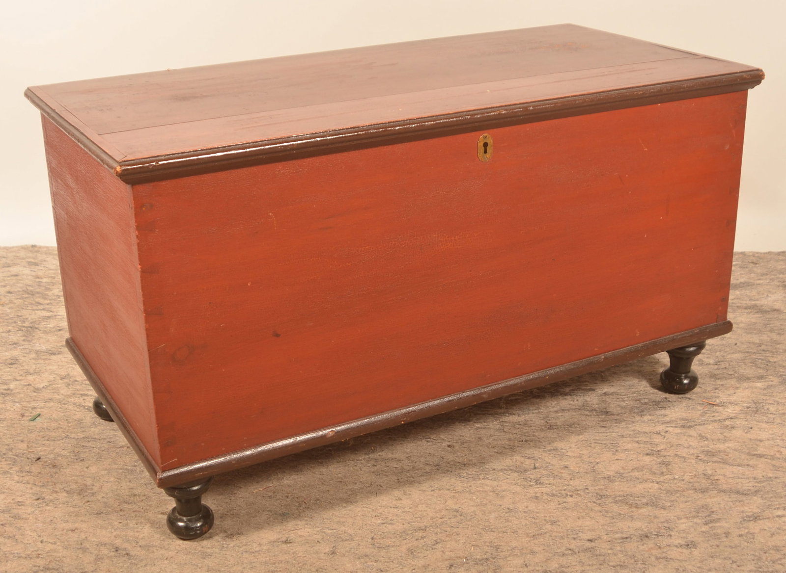 Painted Pennsylvania Turned-Foot Blanket Chest: Lancaster County blanket chest in original 3-tone paint. Red, applied trim in brown and turned feet in black. Dovetailed, ca. 1850. Descended in a family from the Manheim area. 20 1/2"H x 36 1/2"W x 1