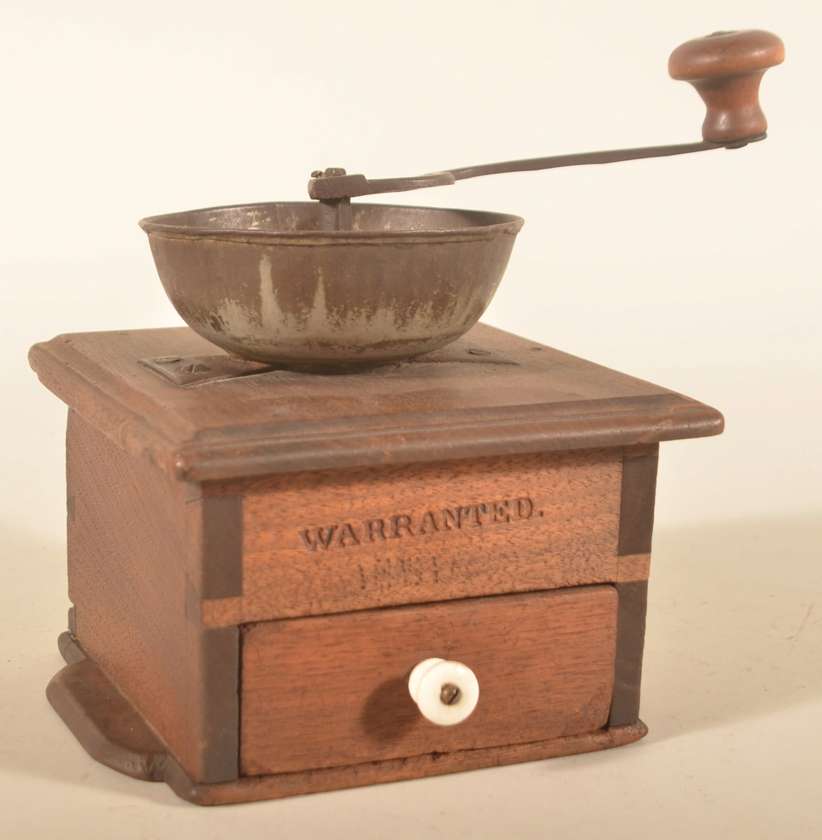 Signed & Dated Pennsylvania Walnut Coffee Grinder: Walnut, pewter top with iron handle, dovetailed case, shaped base, marked on the handle "W.W. Weaver". The front, above the drawer, is stamped "Warranted" with a punched date of "1851". Drawer is nail