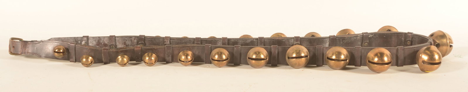 Excellent Leather Strap Graduated Sleigh Bells: Brass bells are embossed with the size number, decoration and are attached to the leather strap with cotter pins. Leather strap is a double strap with leather ties secured with copper rivets. The ends