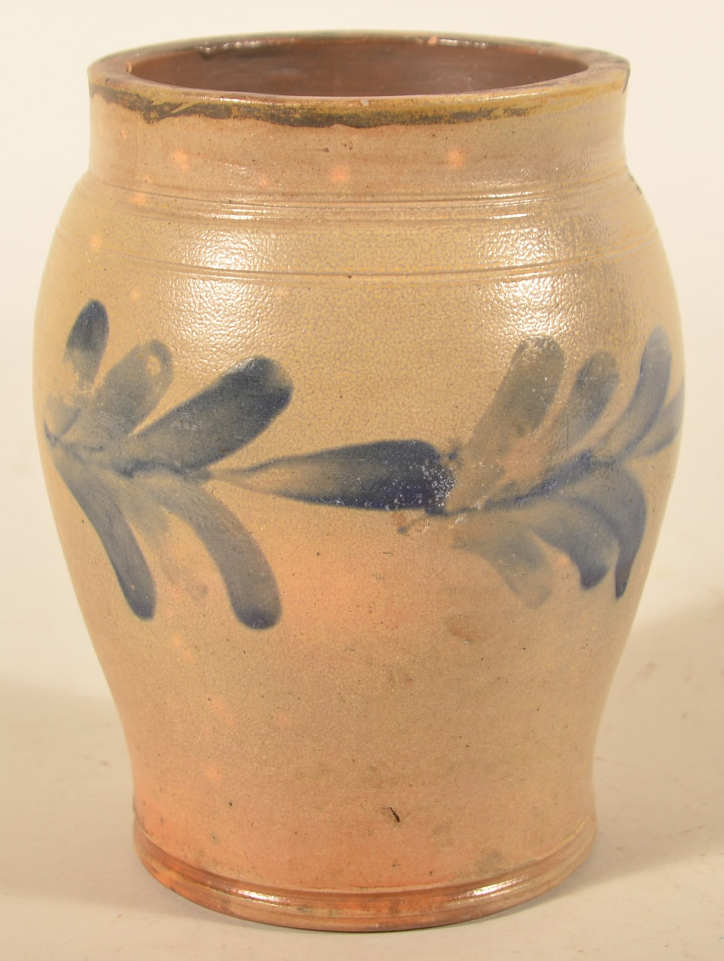 Freehand-Decorated Philadelphia Stoneware Crock: Slightly bulbous storage crock with freehand flourishes around the body of the jar. Tooled lines around the upper shoulder and over glaze runs around the top edge 7 3/4"H