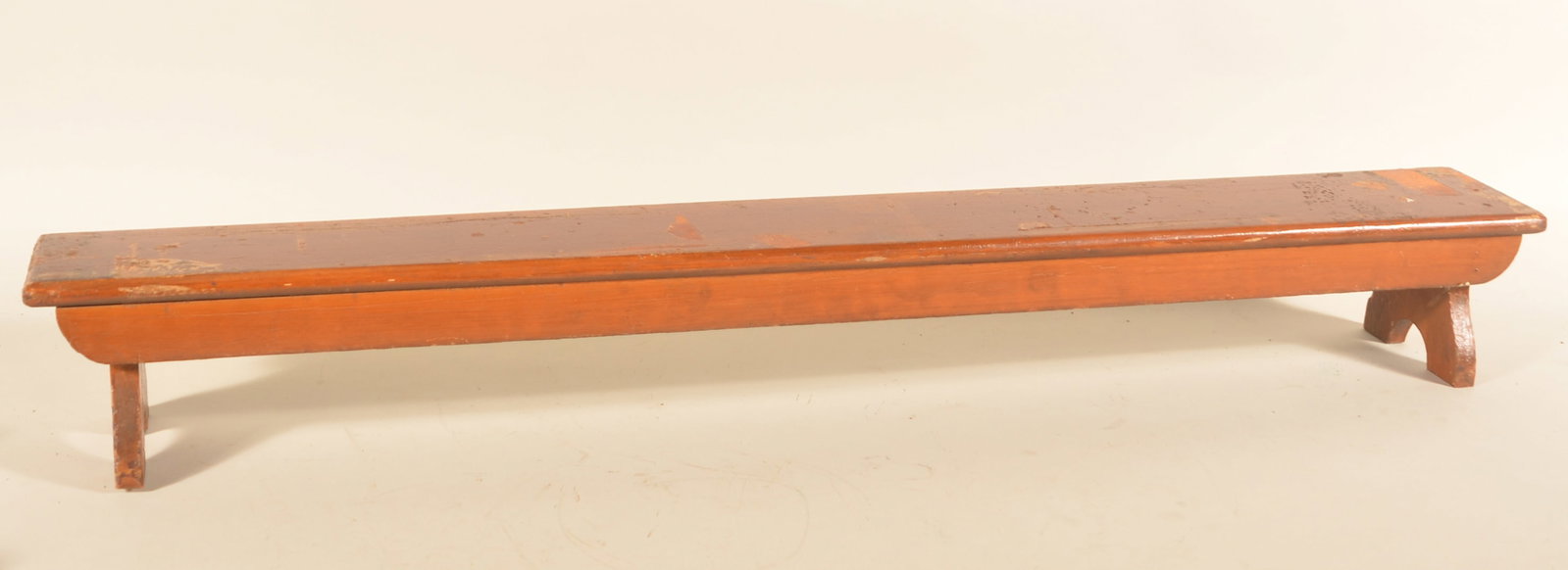 Grain-Painted Wood Kneeler Bench: Late-19th-century grain paint kneeler now used as a riser for display of antiques. Splay legs with half-moon cut-out feet. 7"H x 55"W x 7"D