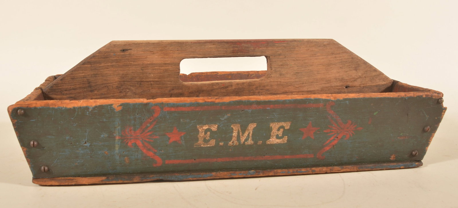 Patriotic Paint-Decorated Antique Wood Tote: Early-20th-century tote in a great dark blue paint, stenciled red stars and design acting as a picture frame for the initials "E.M.E." which are done in white. Repeated on both sides. 13"H x 25 1/2"W 