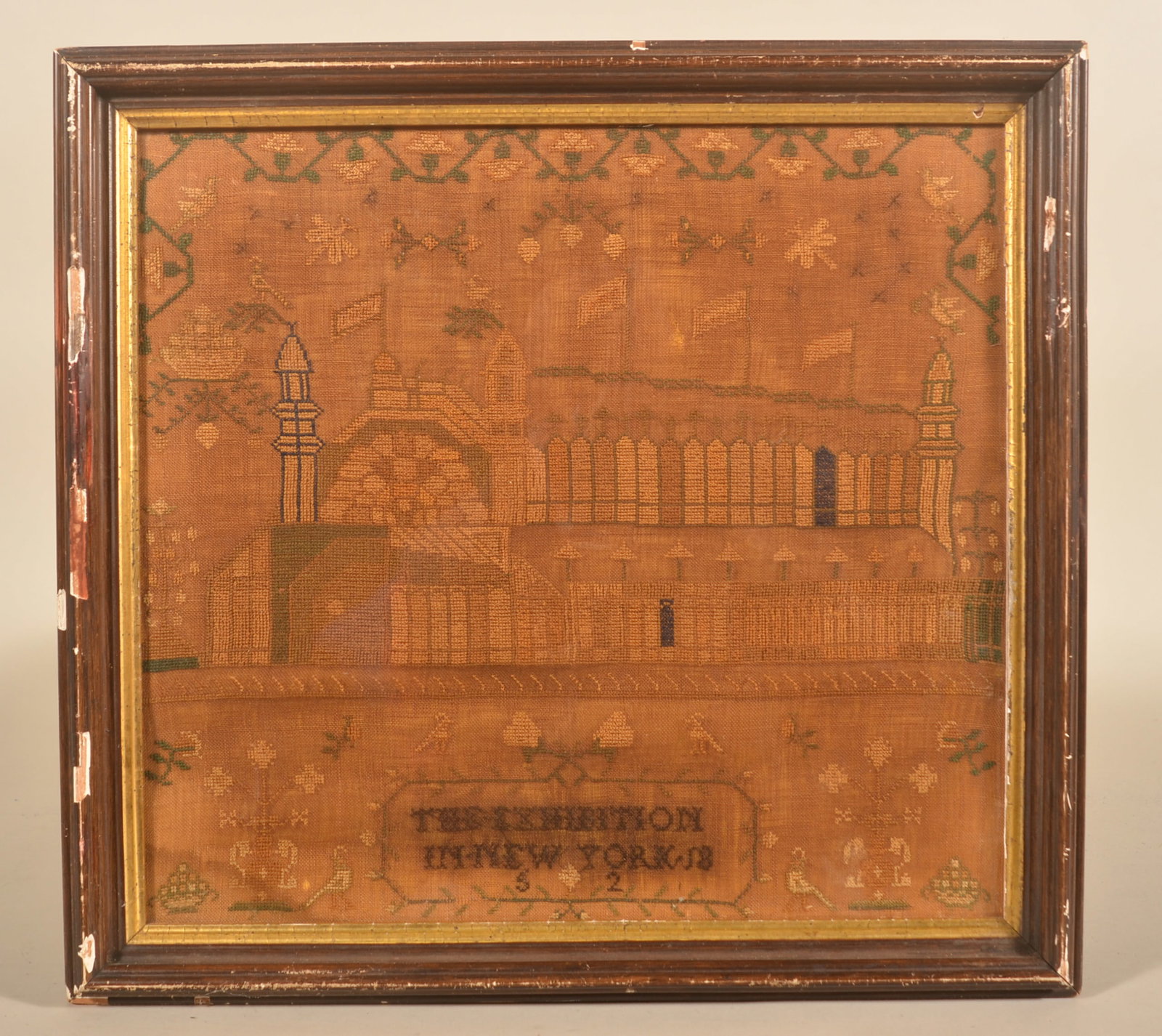 Unusual 1852 NY Crystal Palace Exhibition Sampler: Stitched "The Exhibition In New York 1852". Scene depicts the Crystal Palace in Reservoir Square, now Bryant Park in Manhattan, which was dedicated in 1853. 19 1/2H x 18 1/4"W
