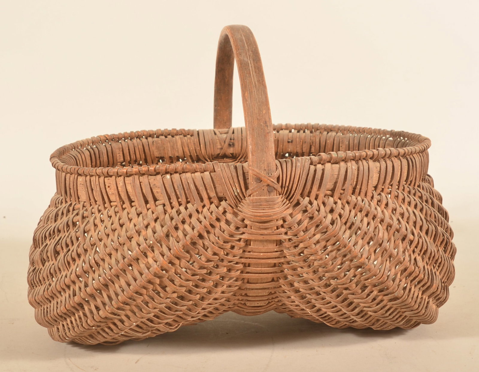 Large Pennsylvania Antique Buttocks Basket: Carved oak handle with splint oak construction. Traditional form. 12"H x 17"W