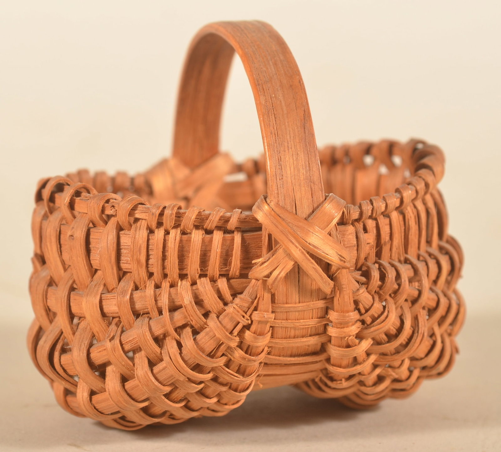 Excellent Pennsylvania Miniature Buttocks Basket: Very nice example of an early 20th-century miniature basket found in Berks County, Pa. Patina and condition are both excellent. 2 3/4"H x 3"W
