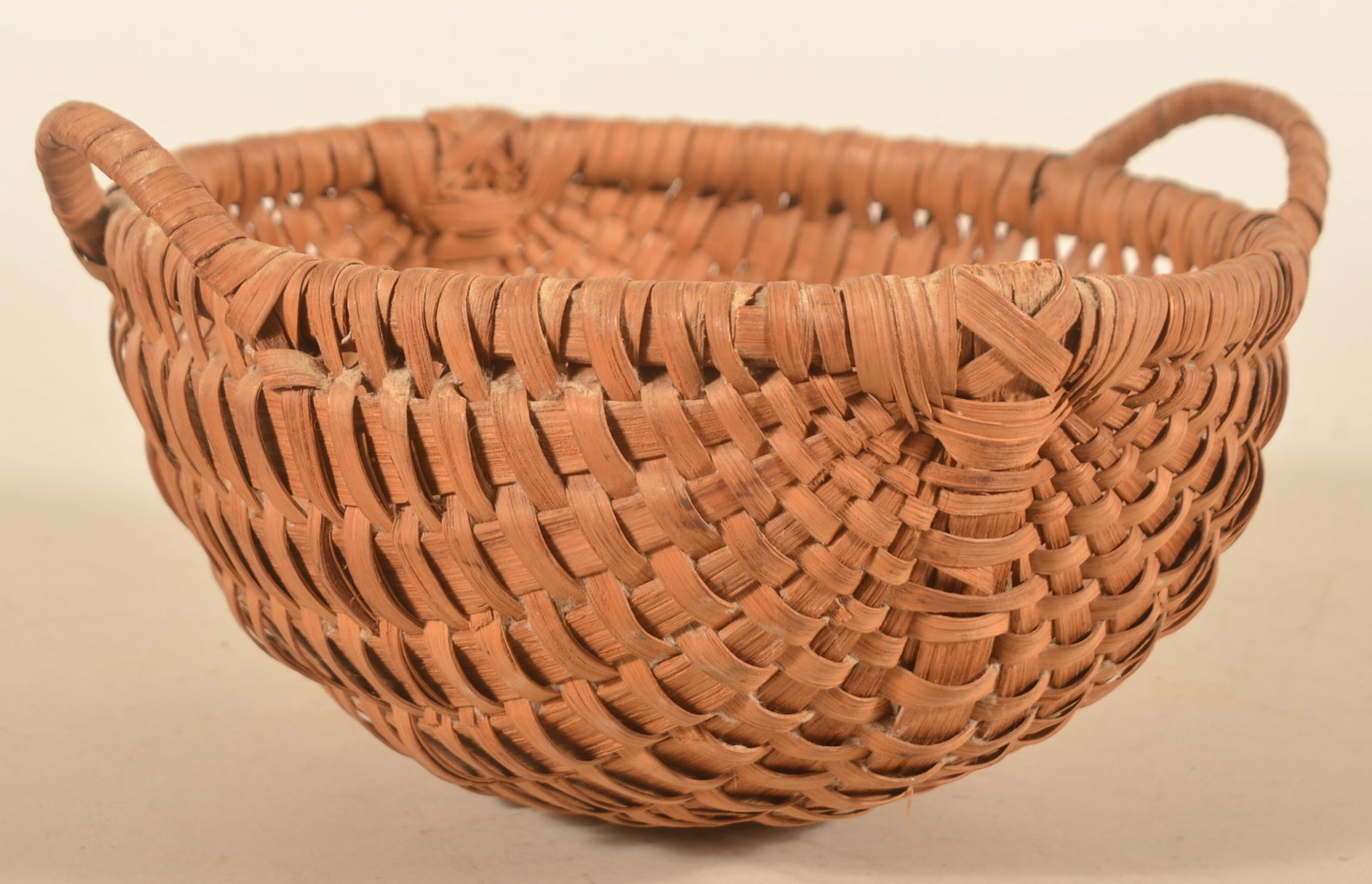 Small Antique Woven Double-Handled Egg Basket: Small splint oak basket with two tightly woven handles, found in central Pennsylvania. 4 1/2"H x 10 1/2"W