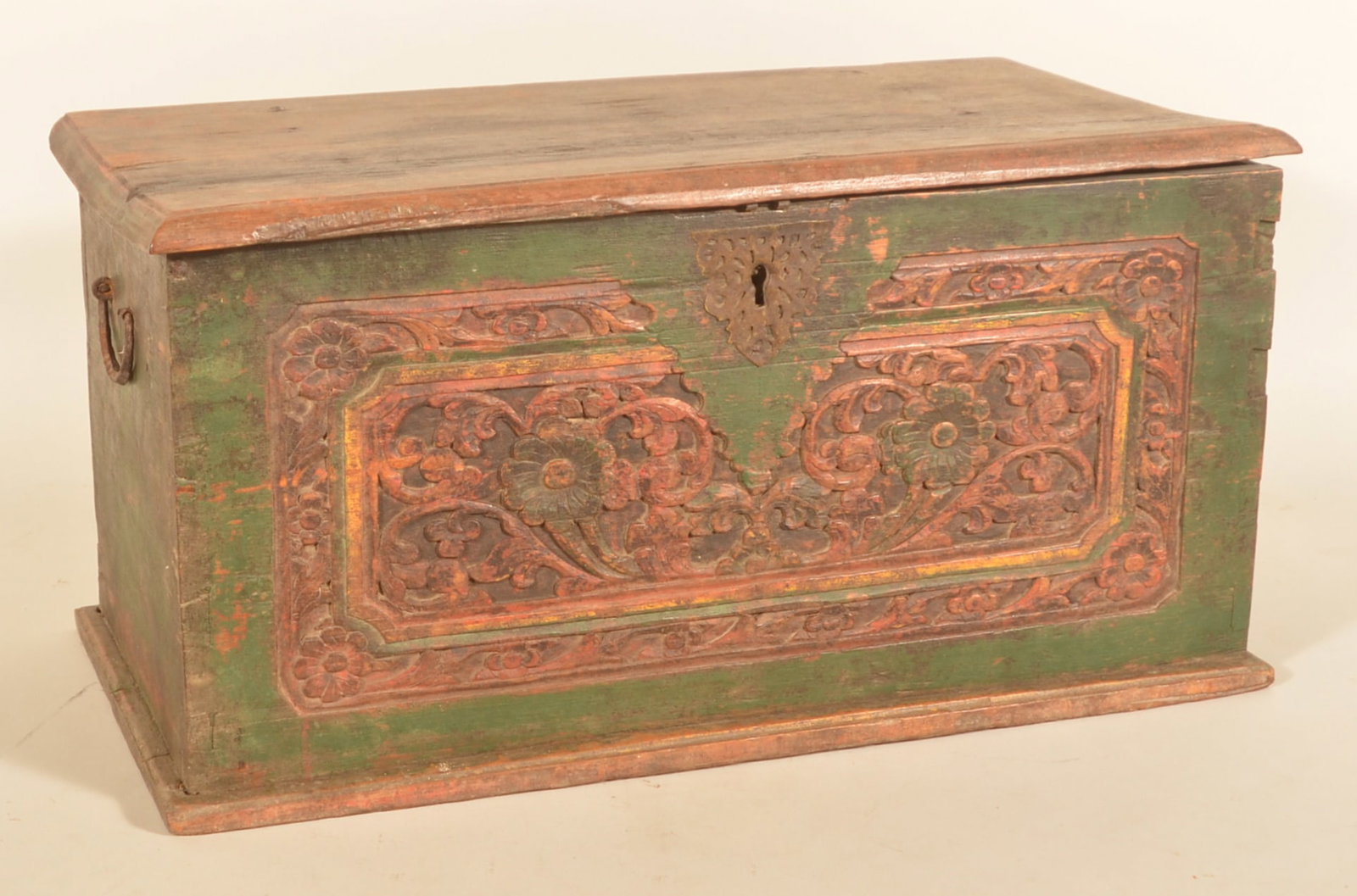 18th C. Carved & Painted Dovetailed Document Box: Continental origin. Oak dovetailed box with carved floral design on front panel surrounding the decorative iron escutcheon. Green paint with mustard and red painted highlights. One iron handle