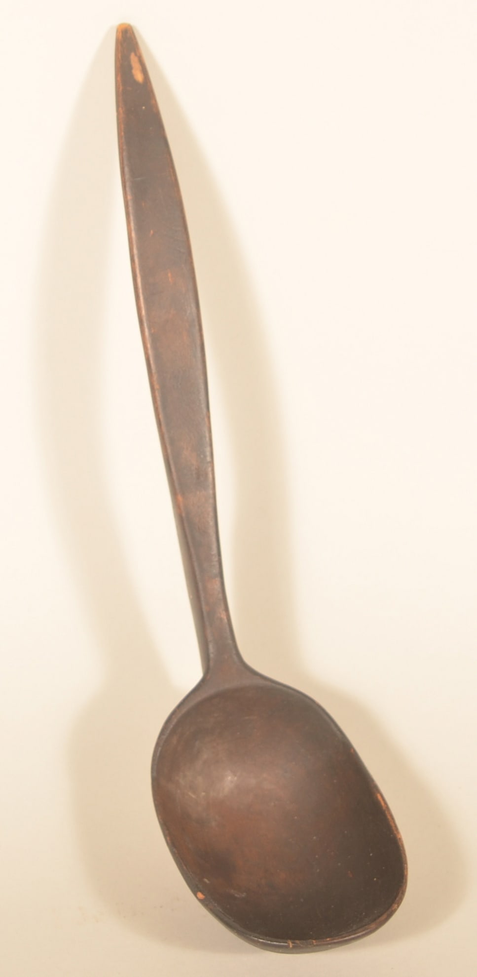 Excellent Carved Native American Wood Ladle: Deep bowl, tapered handle with a dark, uncleaned patina from age. A very old dealer sticker remains on the side. 12 1/2"L