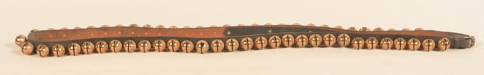 Antique Set of Christmas Sleigh Bells: Excellent complete strand of brass sleigh bells mounted to the leather strap with copper rivets. Bells are the same size. 72"L