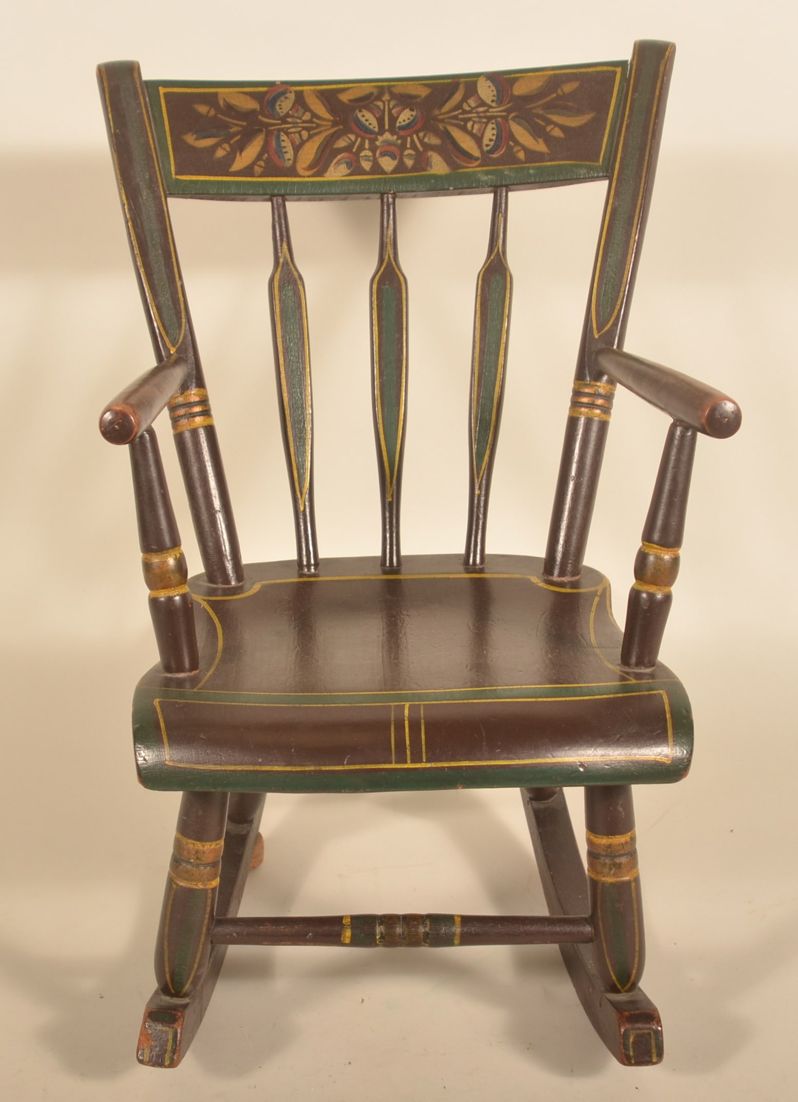 Antique Arrow-Back Paint-Decorated Child's Rocker: Dated 1877, paint-decorated Pennsylvania rocking chair. Signed on bottom "Made in 1877 by John Strickler". 20 1/2"H x 13 1/2"W x 22 1/4"D