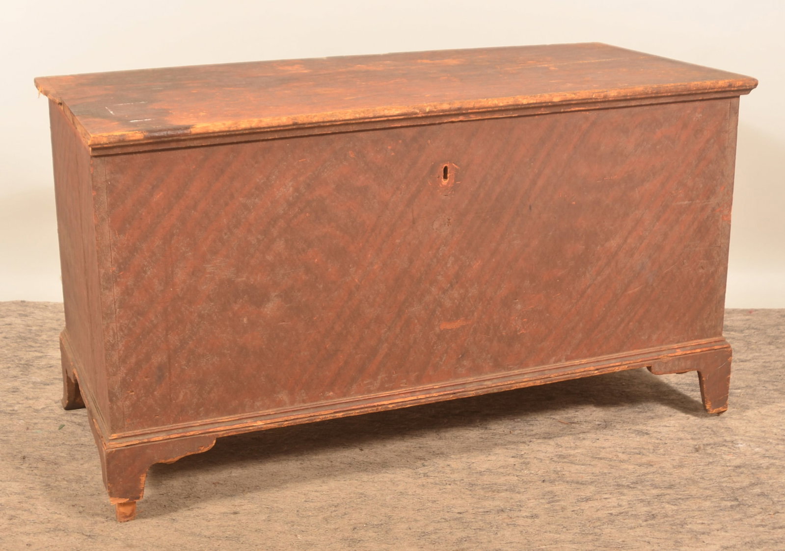 Early Berks Co., PA Paint-Decorated Blanket Chest: Large bracket foot, dovetailed chest in the original red paint with black stripes. Wrought iron tulip shape strap hinges, original escutcheon, lock and key are stored inside the interior till. 26 1/2"