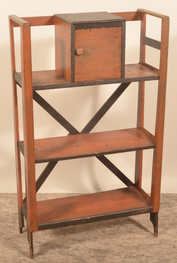 Antique Paint-Decorated Bookshelf: Early-20th-century bookshelf in the original orange paint, trimmed in black, with an unusual cupboard added to the top shelf. 42 1/2"H x 25"W x 10 1/2"D
