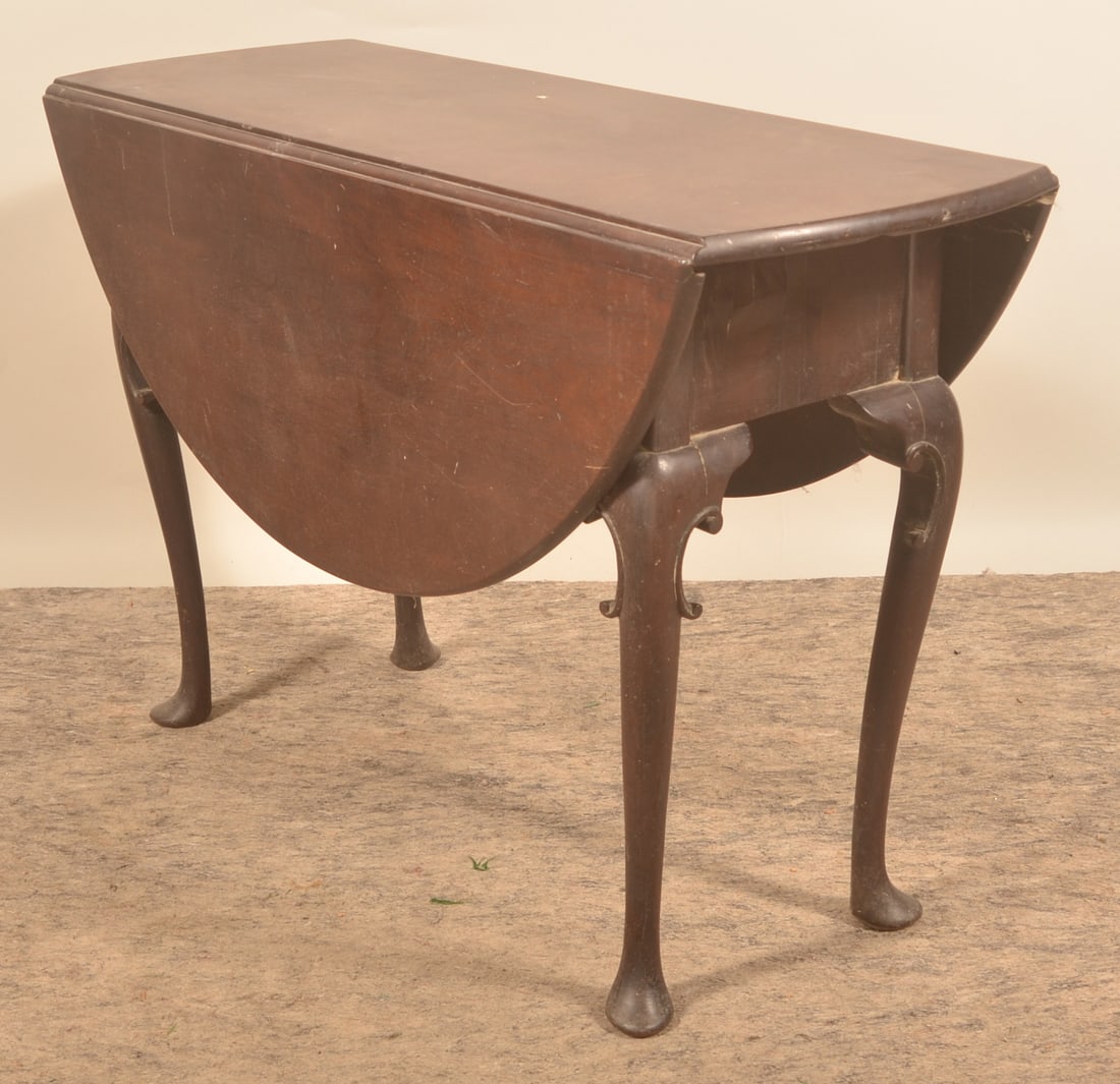 Mahogany Drop-Leaf Table: Period, with cabriolet legs in an early, dirty finish. Early-19th century. 29 1/2" x 43 1/2" x 46"D (when open)