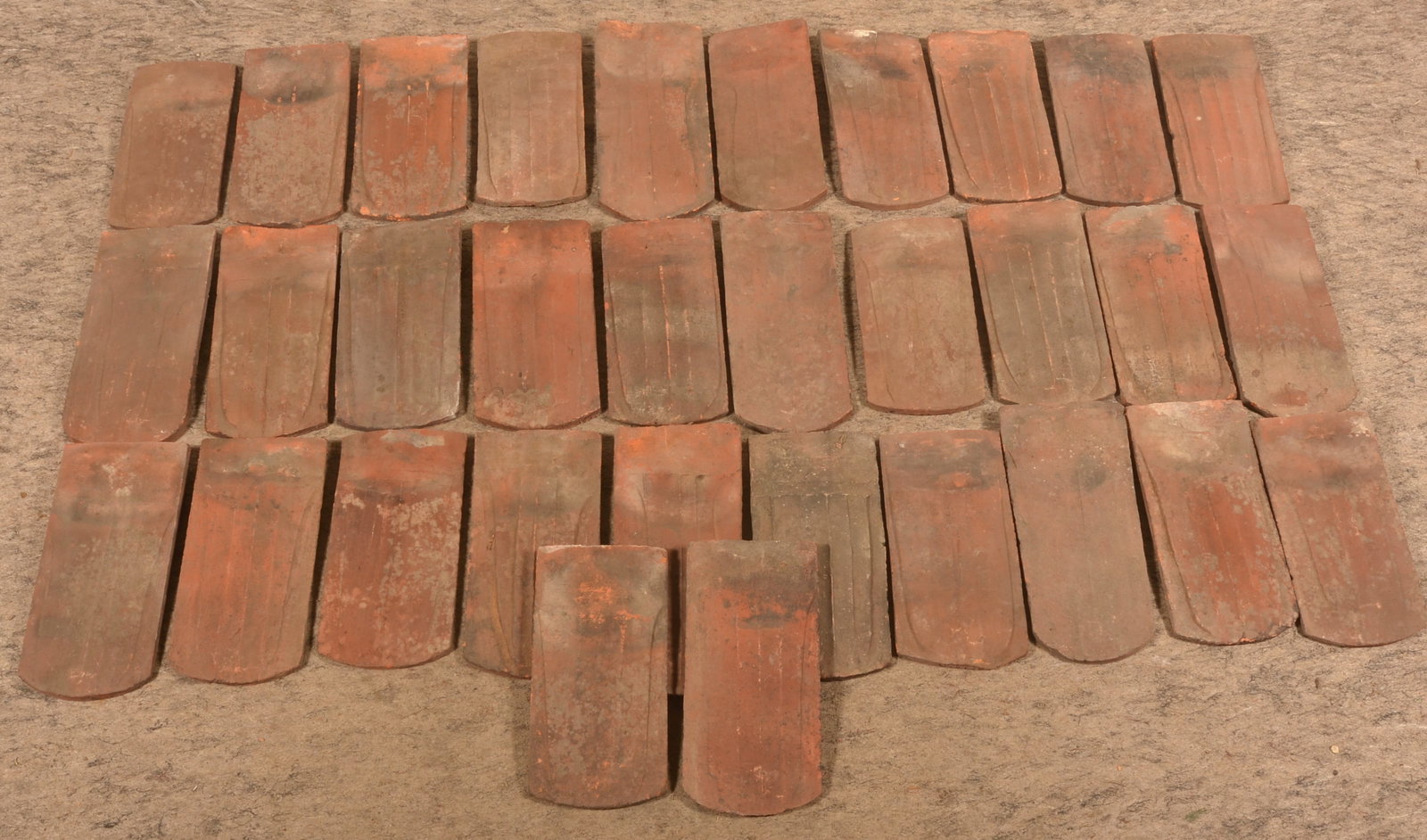 Antique Berks County, PA Redware Roofing Tile: Nice collection of roofing tile with traditional tulip shape for channeling water. 32 tiles. Each, 14 1/2"L x 6 3/4"W