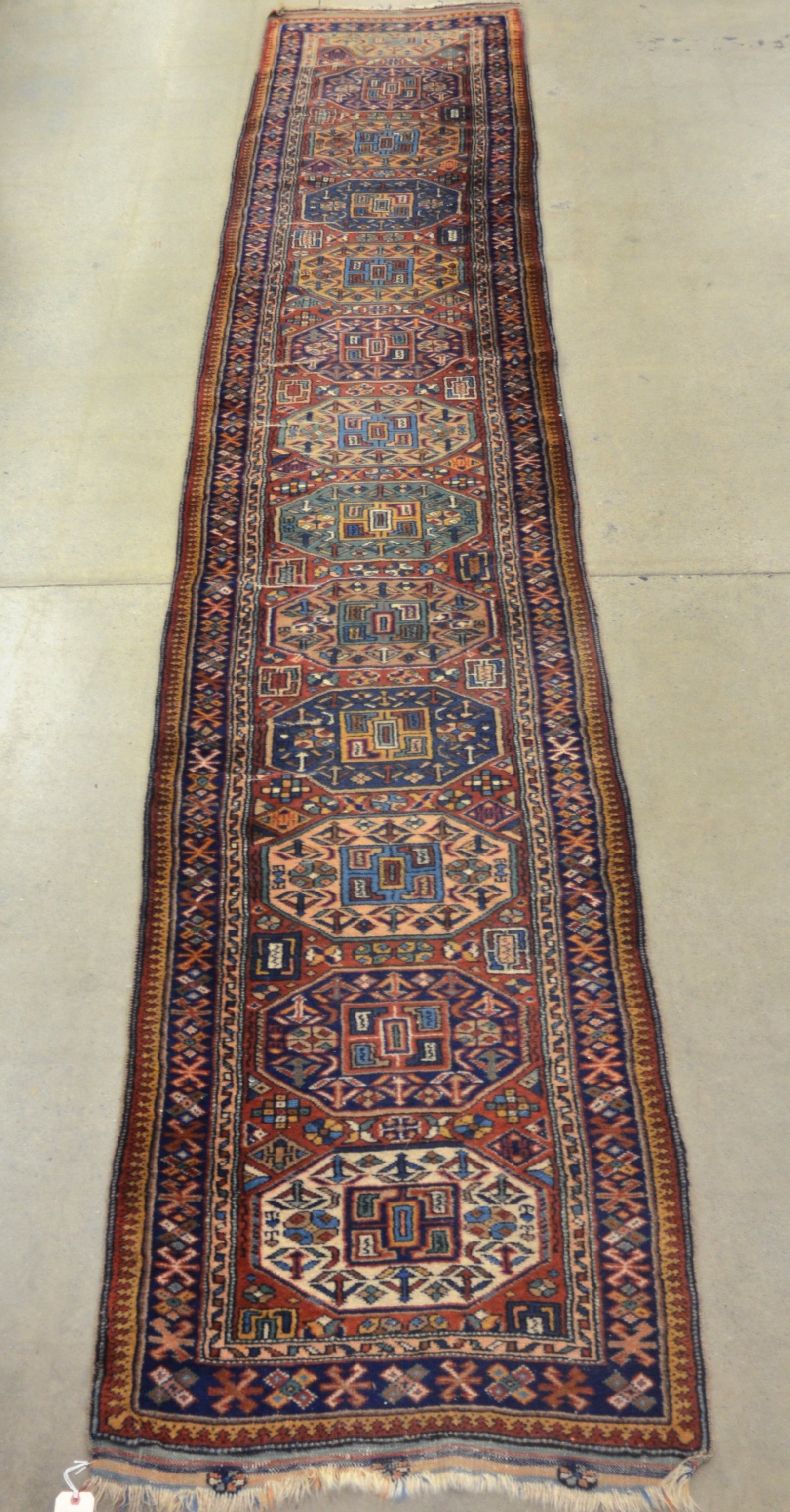 Antique Kazak Hand-Knotted Wool Runner: Geometric and floral pattern with nice dark colors. Early-20th century. 2' 8" x 14' 6"