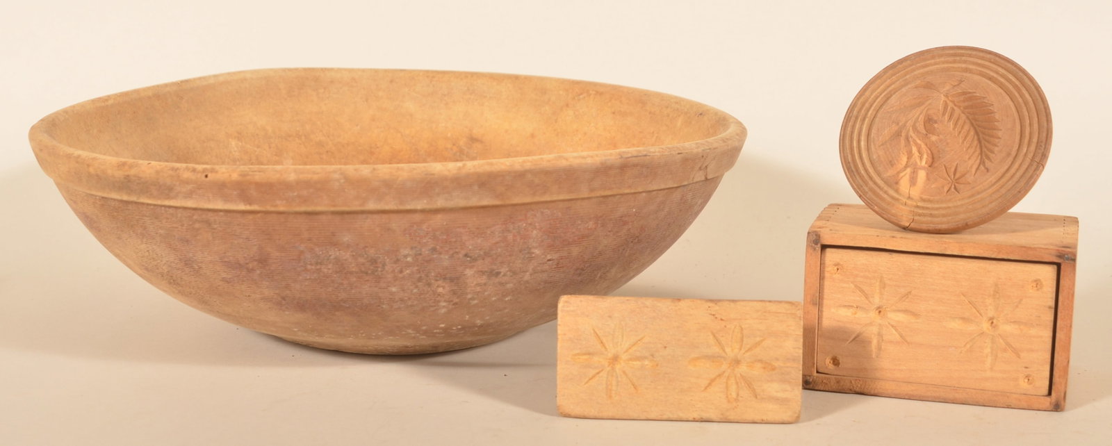 Early Turned Wood Bowl & Butter Prints: Nice group of woodenware including a great, footed wood bowl with a very nice untouched finish and traces of red paint. Together with three butter prints. Four items total. Wood bowl, 16 5/8" diam.