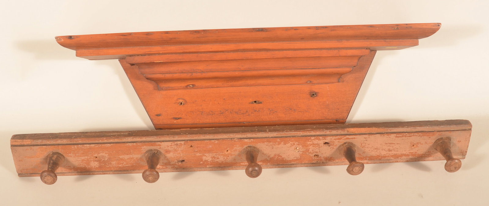 Antique Carved Peg Rail & Wood Clock Shelf: Two antique primitives including a mid-19th-century pine hanging clock shelf and a great size peg rail with five carved pegs and traces of the original putty paint. Peg rail, 31"W