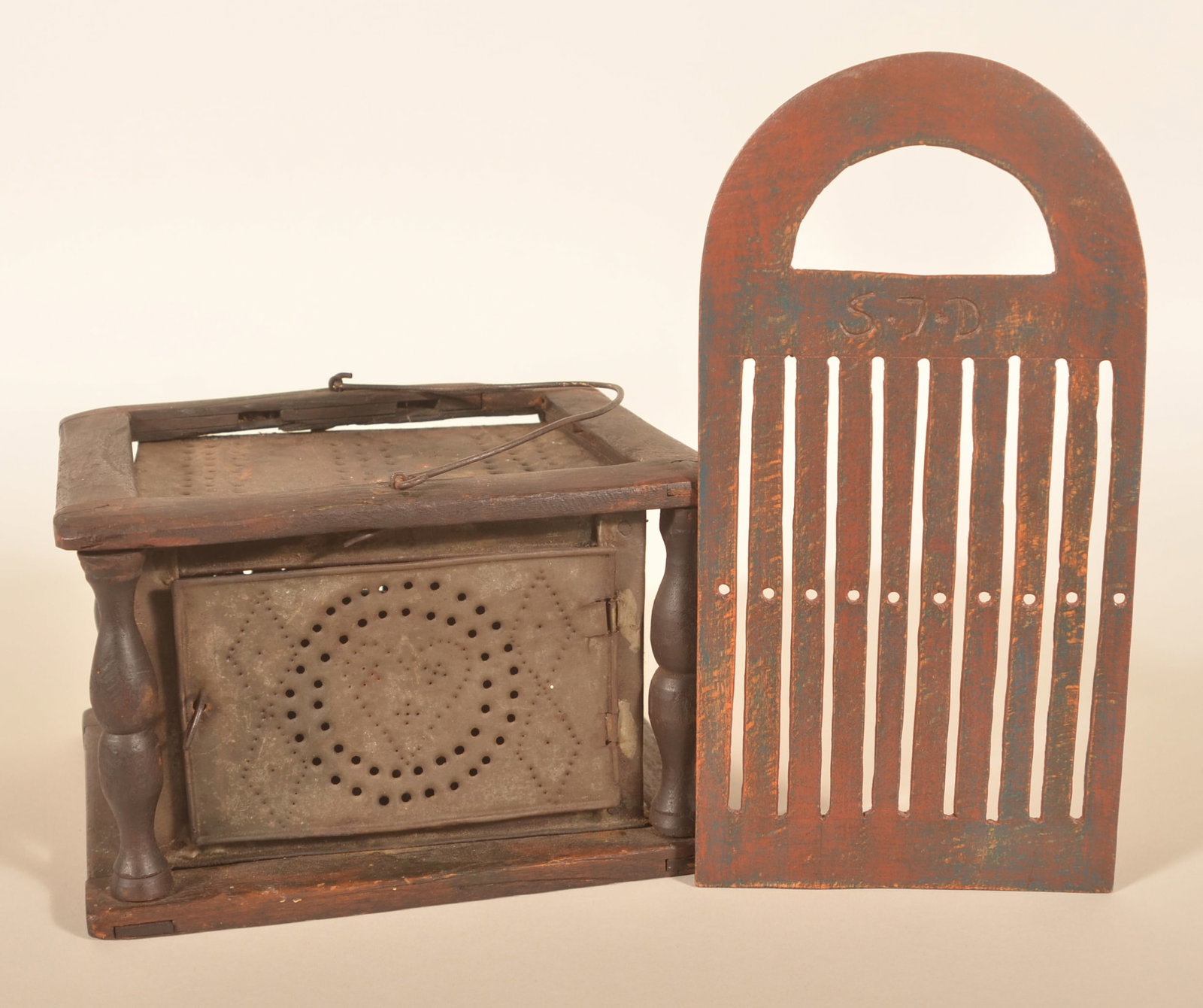 Heart & Diamond Foot Warmer & Painted Tape Loom: Early carved tape loom with initials "SJD" carved below the handle. Red over blue painted surface. Together with an early heart and diamond punched-tin foot warmer. Walnut mortised frame with turned c