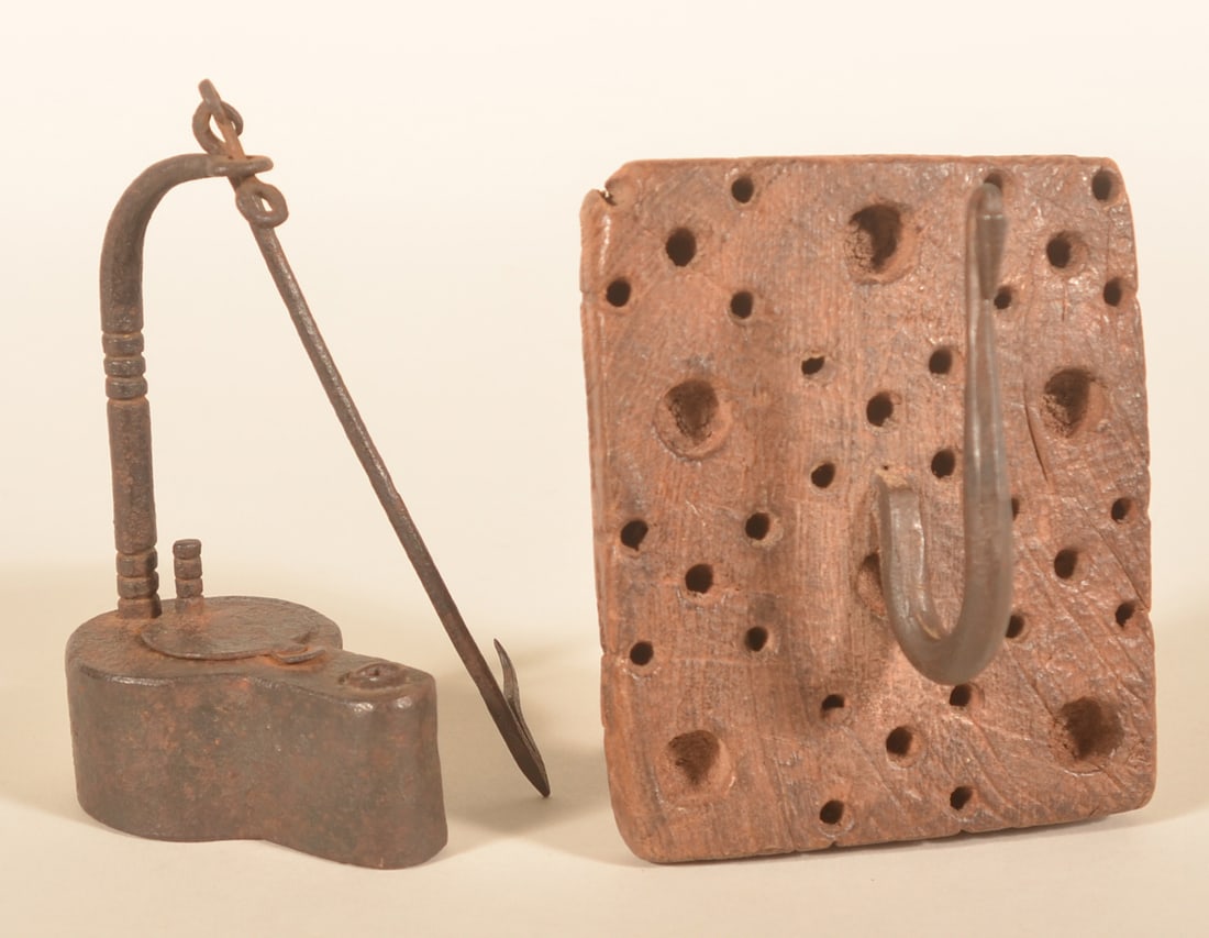 Early Iron Betty Lamp & Wall Holder: Very nice mid-19th-century wrought iron betty lamp with file work done on the post to open the cover and the main arm. Together with an early carved and gouged small oak board with iron hook that has 