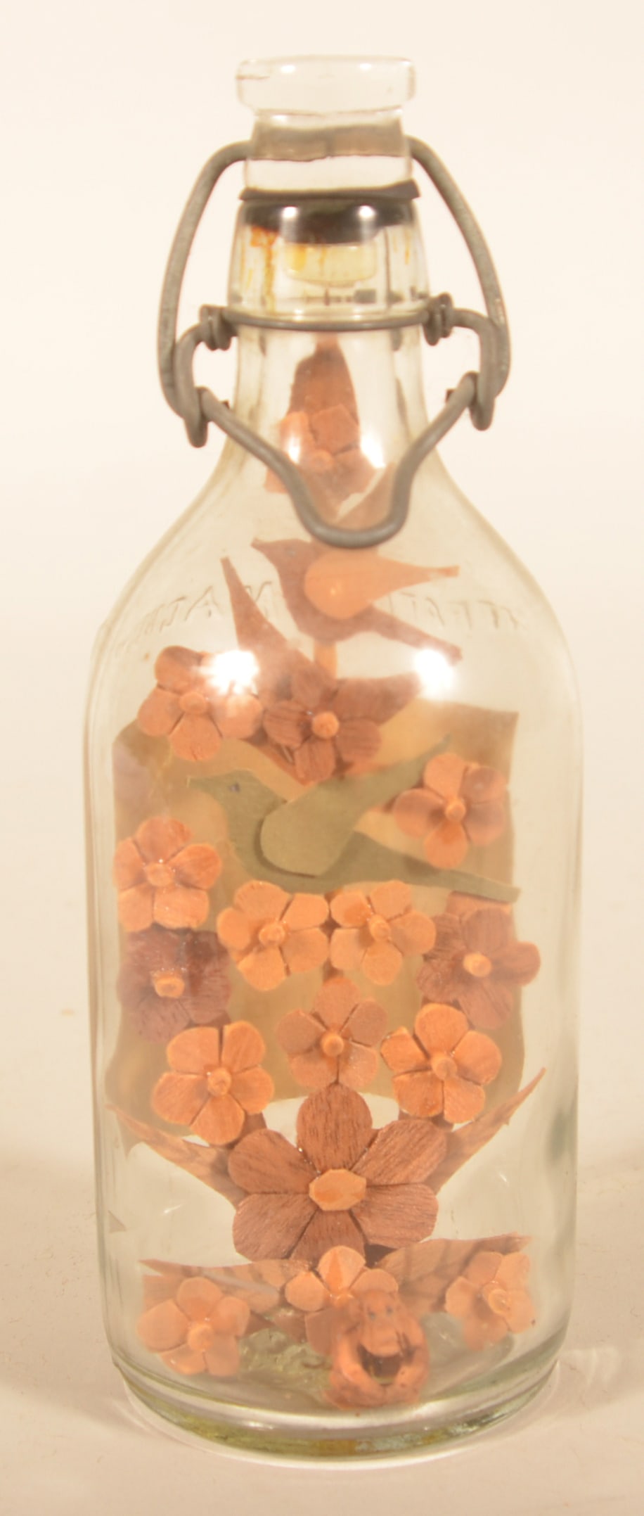 Folk Art Wood Carved Bird Tree Inside Bottle: Bottle with paper label advertising Citrate of Magnesia sold by a druggist in Schuylkill Haven, Pa. Inside is a folk art carving of a tree with several birds and a monkey seated on the ground. 8"H