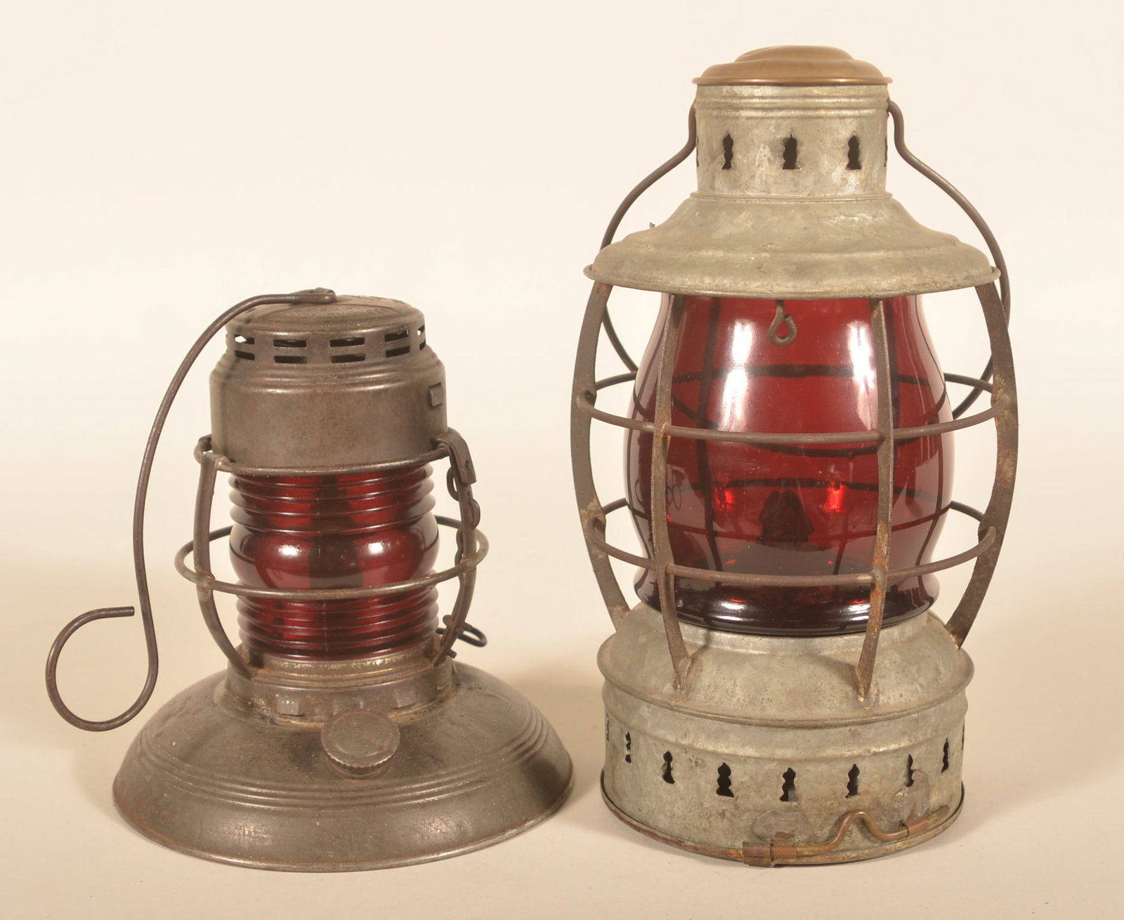Perko Perkins Nautical & Embury Traffic Lanterns: Group of two lanterns with red globes. The nautical lantern is not marked. Traffic "Gard" lantern embossed on cap. Provenance: The collection of Linda and the late Ed Althouse. Perko lantern, 11 1/2"H