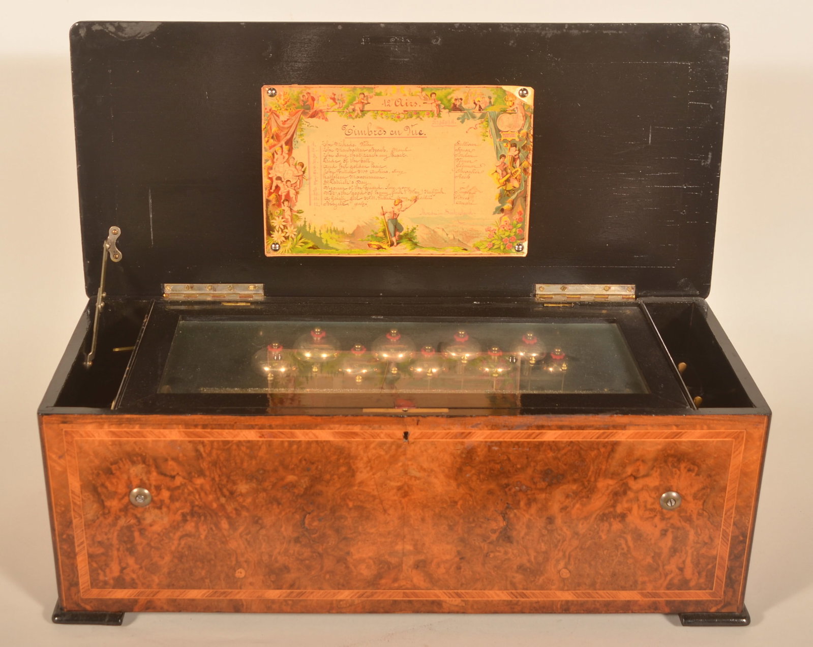 Beautiful Large 19th C. Swiss Cylinder Music Box: 12 "Airs" cylinder music box, ca. 1875, complete with bells. Burl walnut veneer with black lacquered feet trim and interior of box. Serial number 22014. 10"H x 28"W x 12"D