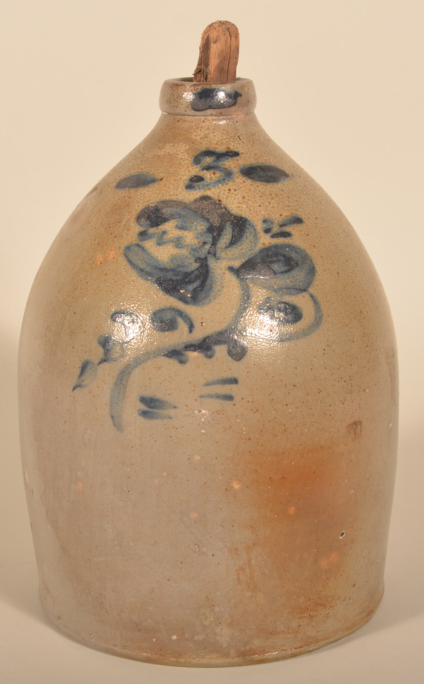 3-Gallon Salt-Glazed, Freehand-Decorated Jug: Possibly New York with freehand capacity mark and a tulip with additional freehand embellishments including on the front edge of the spout. Partial wood stopper. 16"H