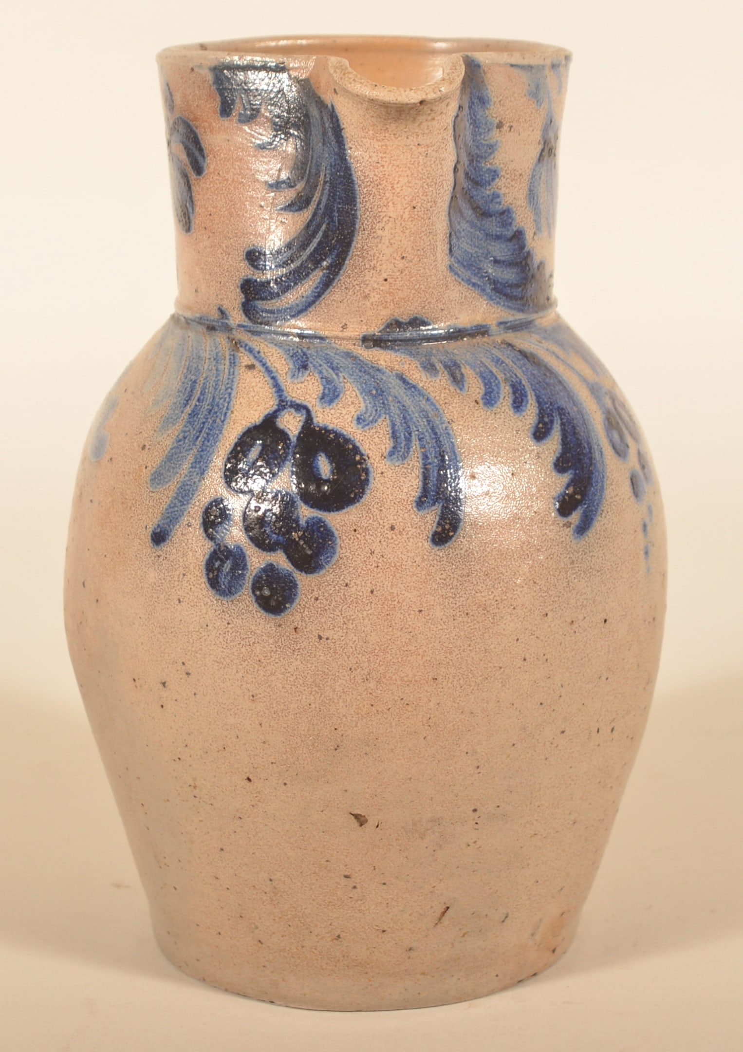 Excellent Baltimore Stoneware Pitcher w/ Grapes: Unusual cobalt freehand decoration featuring four hanging clusters of grapes with floral decorations and an impressed "1" on the collar. Very nice blue/gray contrast. Possibly Perine from Baltimore, t
