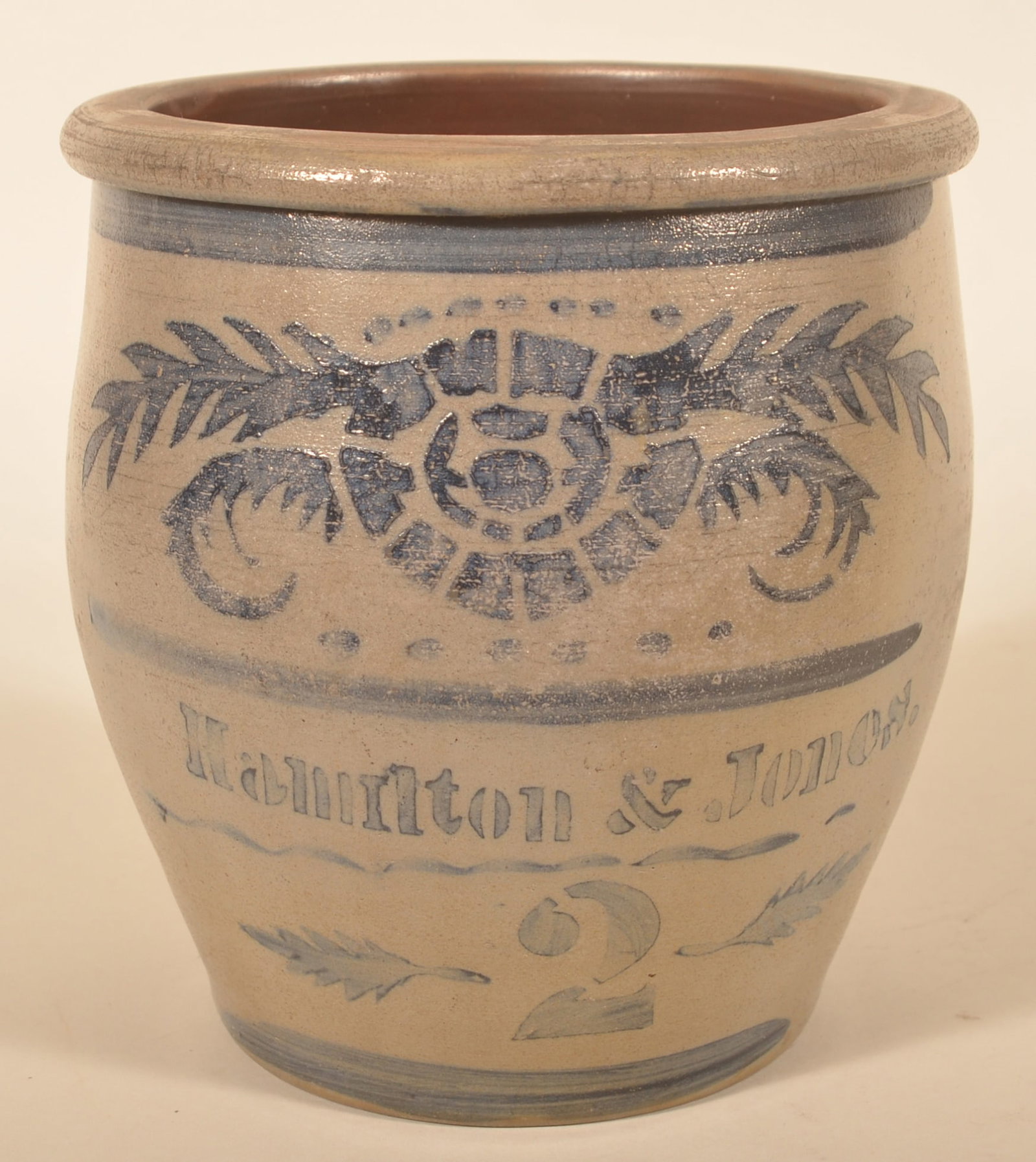 Heavily Decorated 2-Gal. Hamilton & Jones PA Crock: Hamilton & Jones crock from Greensboro, Pa. with a very unusual, stenciled flower and wreath decoration. The "2" with stenciled leaves to either side. Freehand stripes, dots and lines included. A lot 