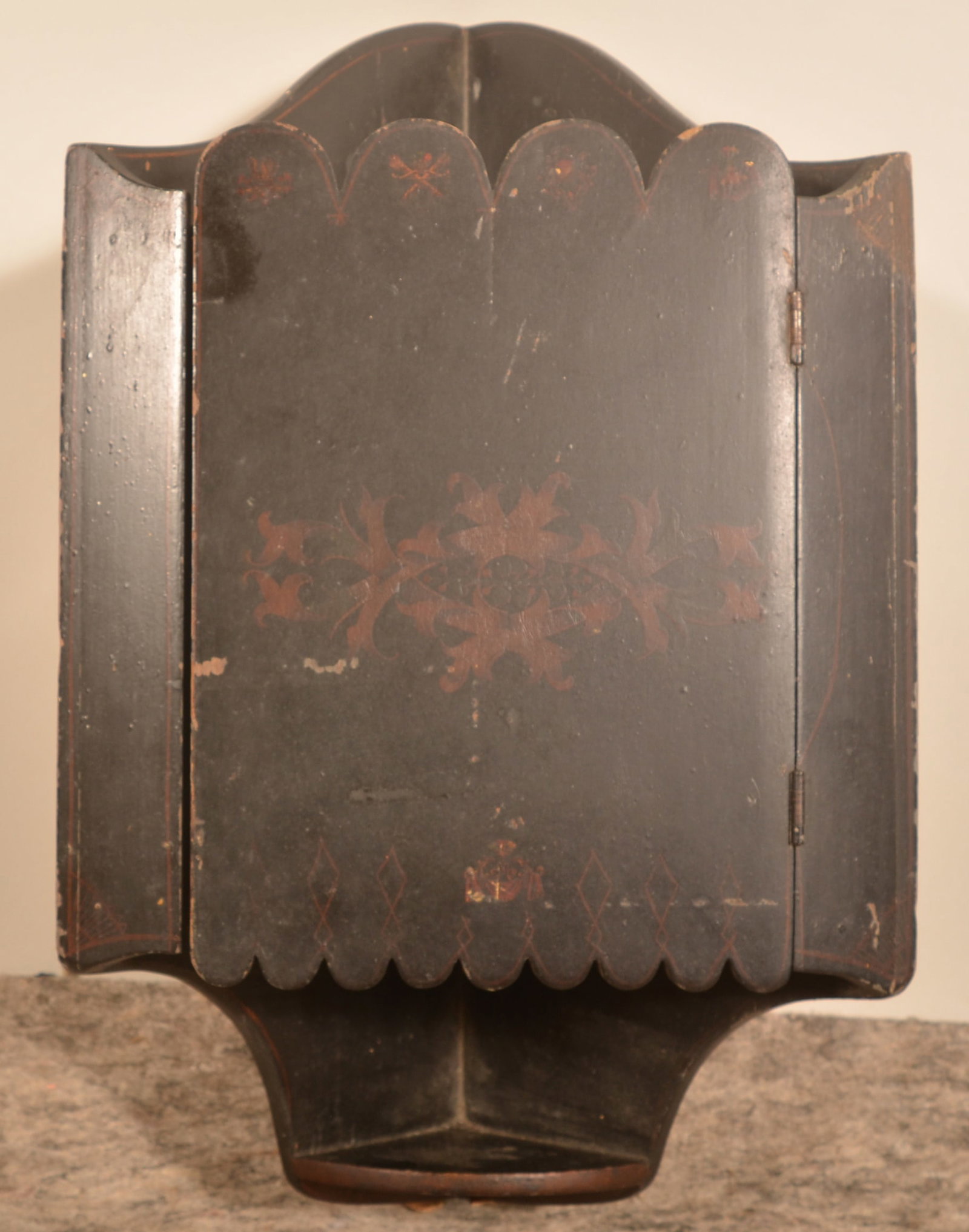 Paint-Decorated Hanging Corner Cupboard: Late-19th century. Small Eastlake-style hanging cupboard with lollipop finials on the top and bottom of the door, candle shelf and a dark lacquered finish with applied decoration. 24 1/2"H