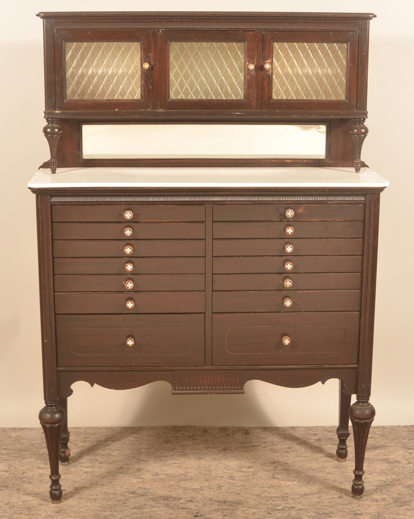 Antique 14-Drawer Dental Cabinet On Legs: Very nice cabinet in a seldom seen configuration with 3 doors over a porcelain shelf over 14 drawers. Turned supports for the top and nicely shaped legs. Original mahogany finish. Main shelf is glass