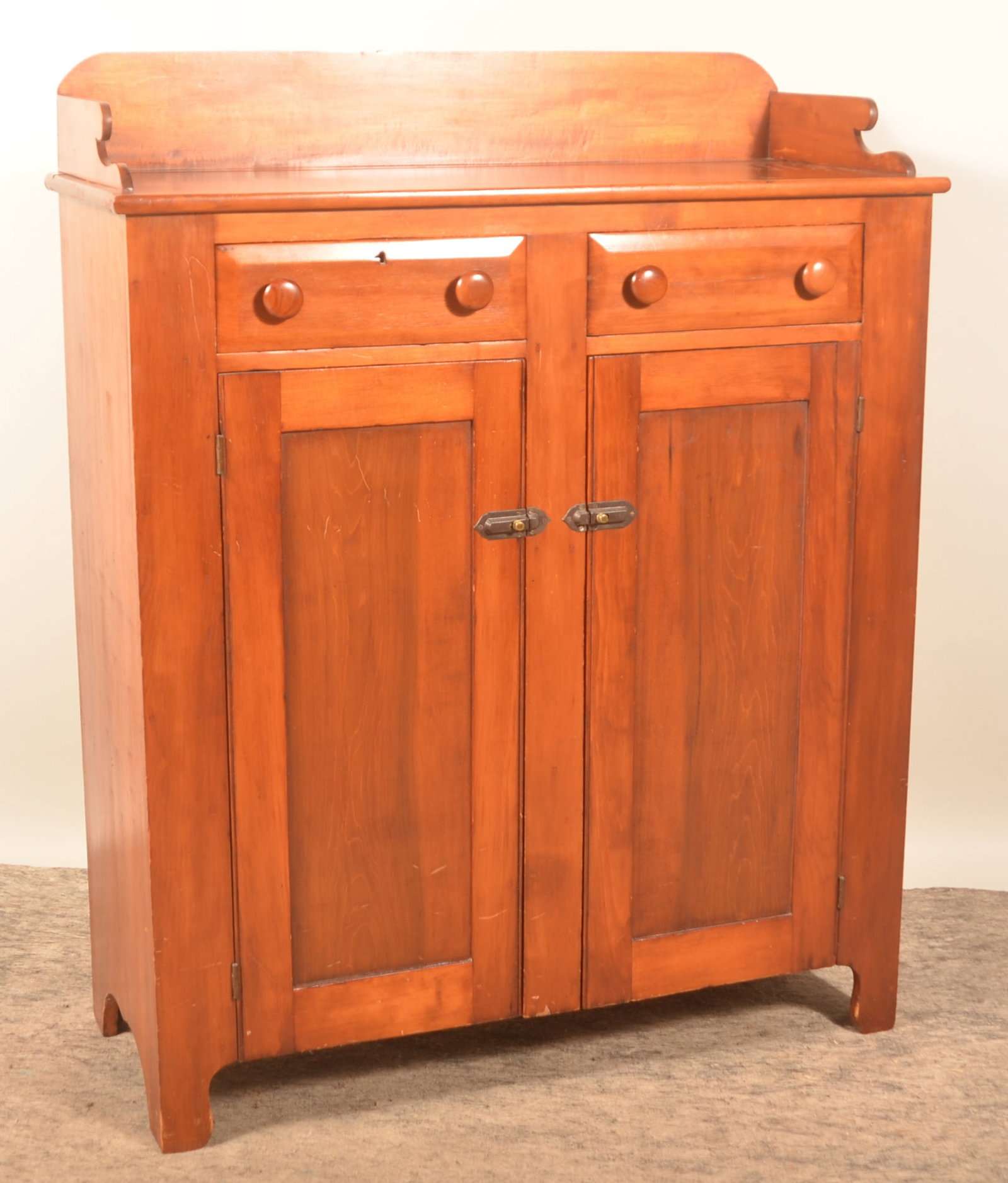 Pennsylvania Jelly Cupboard: Two drawers over two recessed panel doors, mixed woods, shaped backsplash. Interior painted. 54"H x 44"W x 17 3/4"D