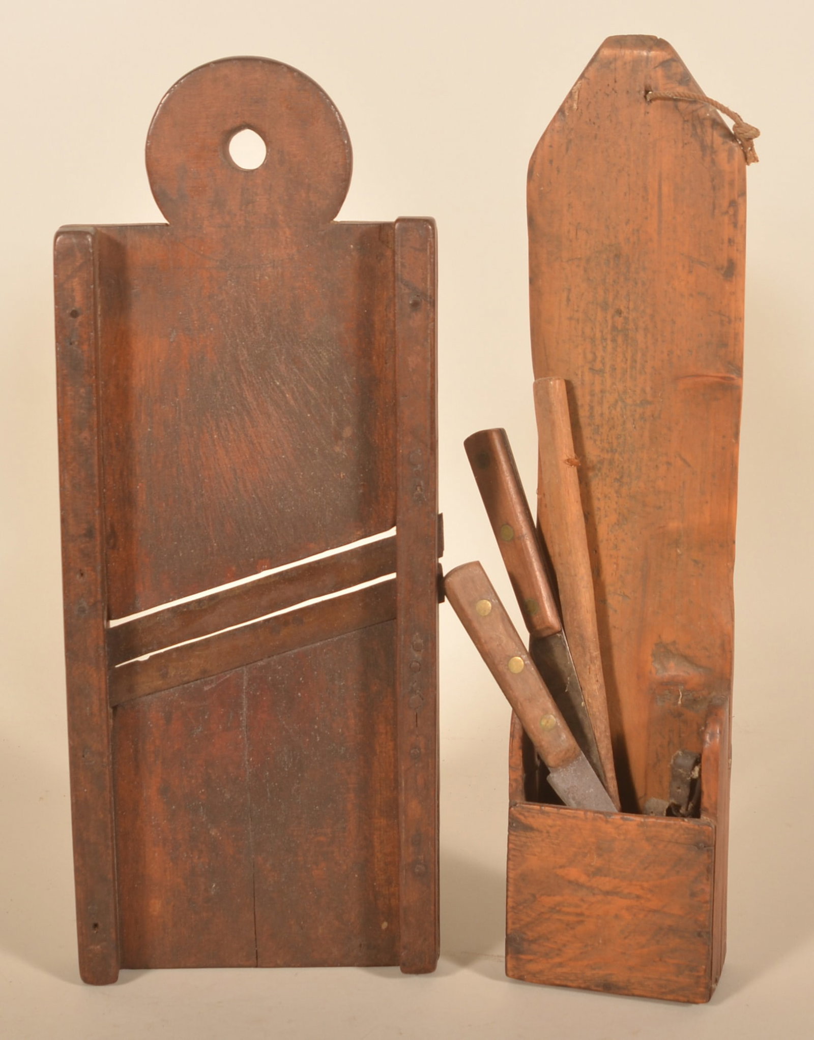 Pipe Box & Cutting Board w/ Lollipop Handle: Two wood primitives including a pine hanging pipe box with tall backboard and an early Pennsylvania cutting board with lollipop-shaped handle. Pipe box with some early utensils. Provenance: The