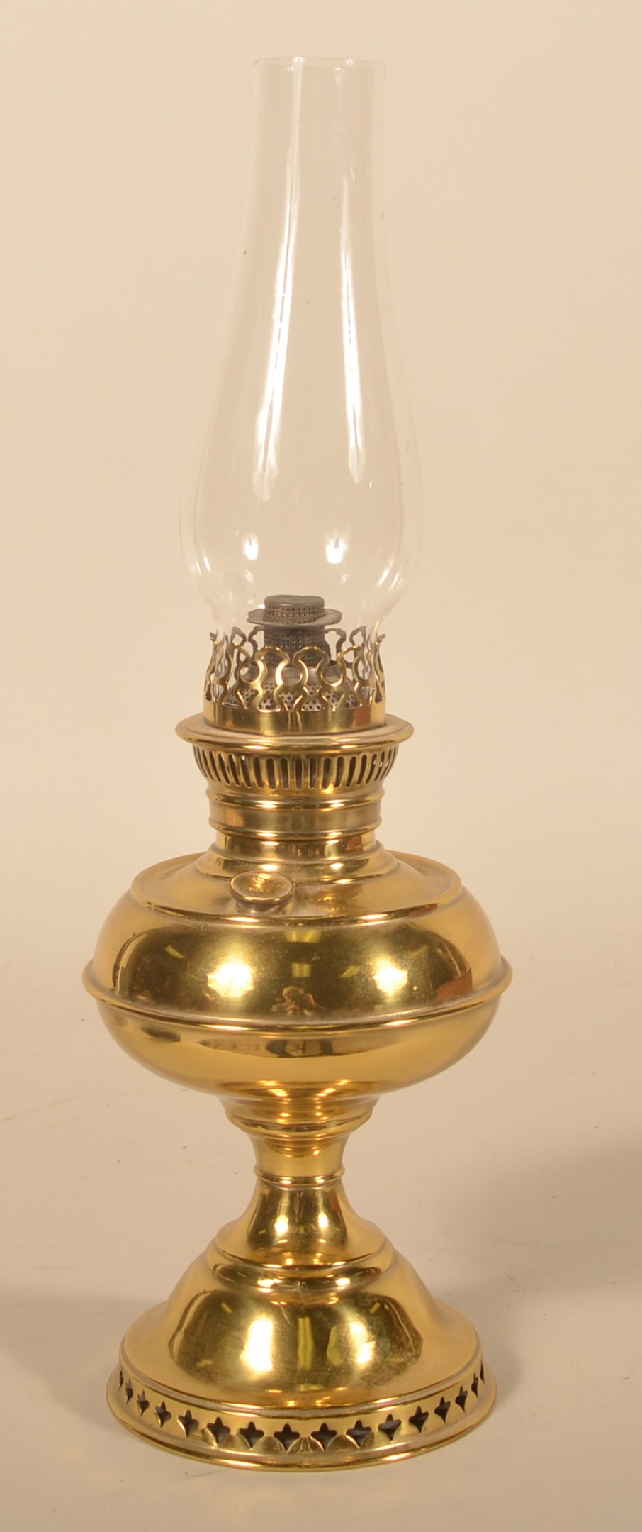 Small Antique Junior Rayo Brass Oil Lamp: More difficult to find "Junior" version of the Rayo light made under contract for Standard Oil Company in the early-20th century. Includes the original etched Junior Rayo glass chimney. 11"H w/o