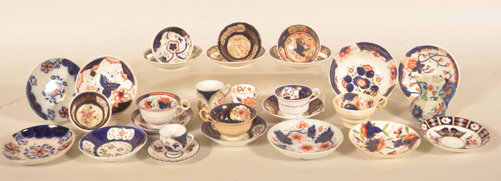 Antique Gaudy Welsh Cups & Saucers: Various patterns, English, early to mid-19th century. 1 small bowl, 1 ironstone creamer, 10 cups and 15 saucers. Provenance: The collection of Linda and the late Ed Althouse. Bowl, 3 1/4"H