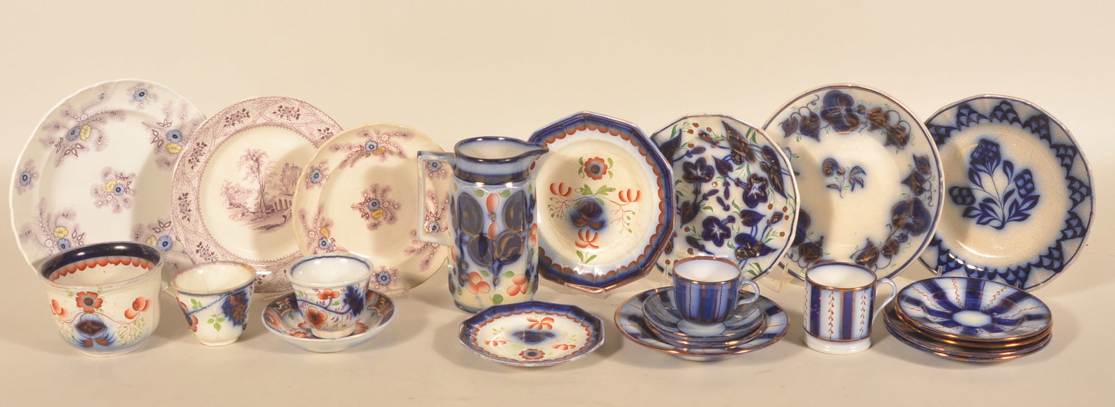 Antique Gaudy Ironstone & Transferware: Nice group of antique China in different patterns. Group includes a pitcher, salad bowl, 16 saucers and plates, 3 cups and 1 mug. Provenance: The collection of Linda and the late Ed Althouse.