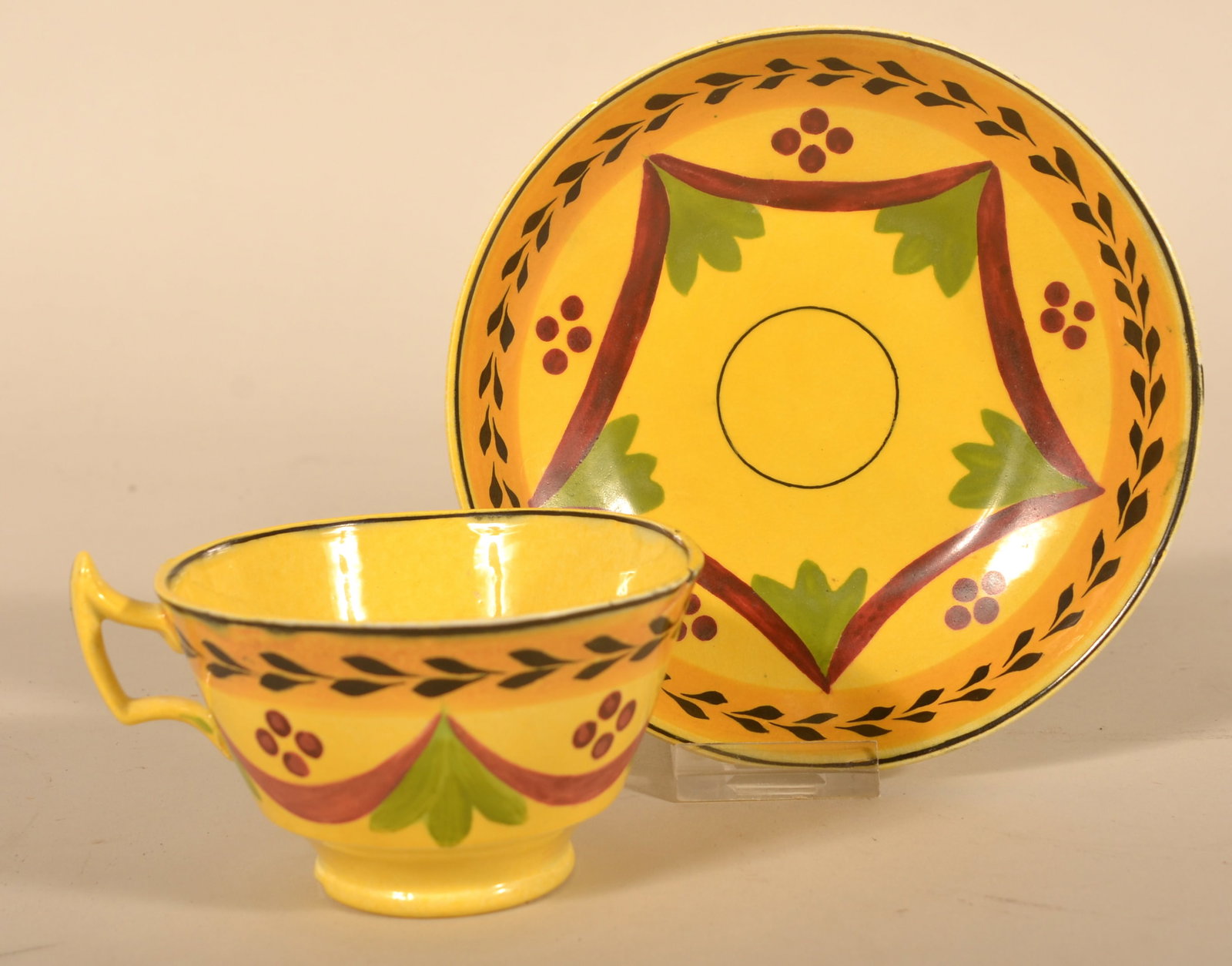 Antique Painted Canary Yellow Staffordshire: Beautiful 5-color cup and saucer. Painted canary yellow with red dots, swags and floral decoration. Ca.1820. 2 1/2"H