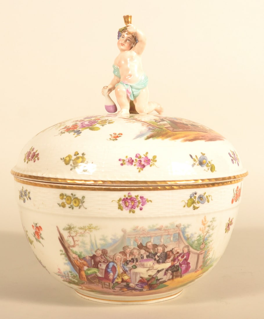 German KPM Porcelain Lidded Punch Bowl & Stand: Porcelain lidded punch bowl featuring a putto raising a goblet on the lid with hand-painted floral decoration and scenes of revelry on the bowl. Very nice figural brass stand. 13"D