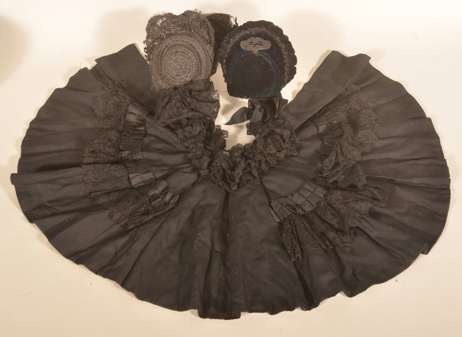 Antique Victorian Mourning Cape & Hats: Descended in a family from Ephrata, Pa. an 1880s woman's black cape with lace, a straw bonnet with lace and a velvet hat with metal emblem on front. Three pieces kept inside the tin container for