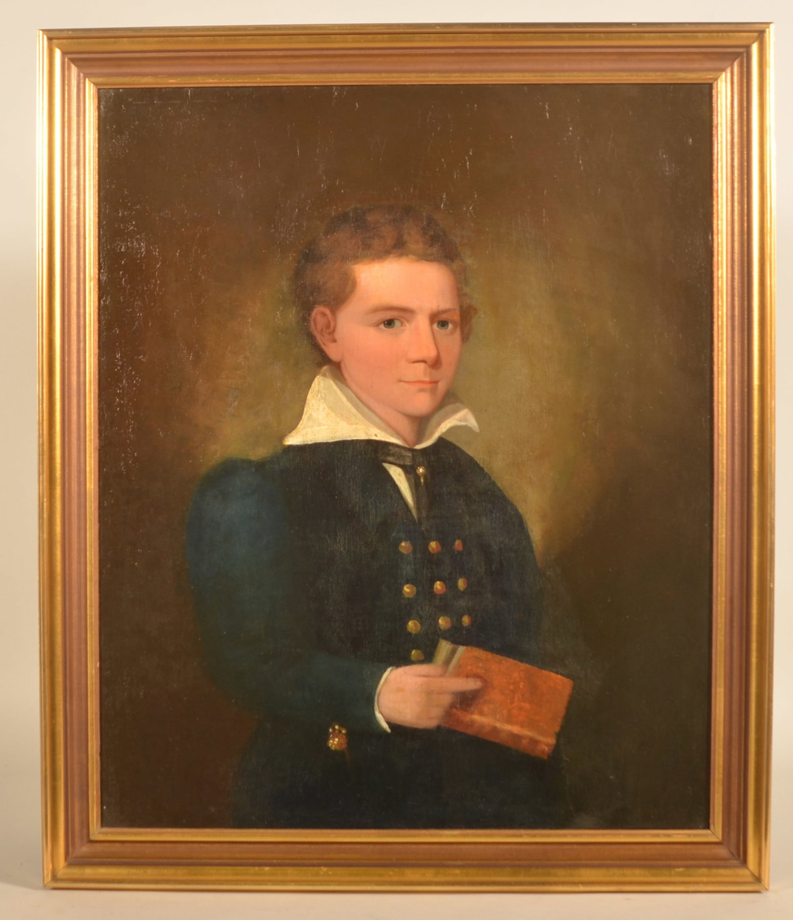 Antique Pennsylvania O/C Young Man w/ Book: Unsigned oil on canvas painting depicting a young man wearing 1820-1830s era clothing while holding a book. Painting was relined and reframed in the 1930s and comes with history related to the Stocket