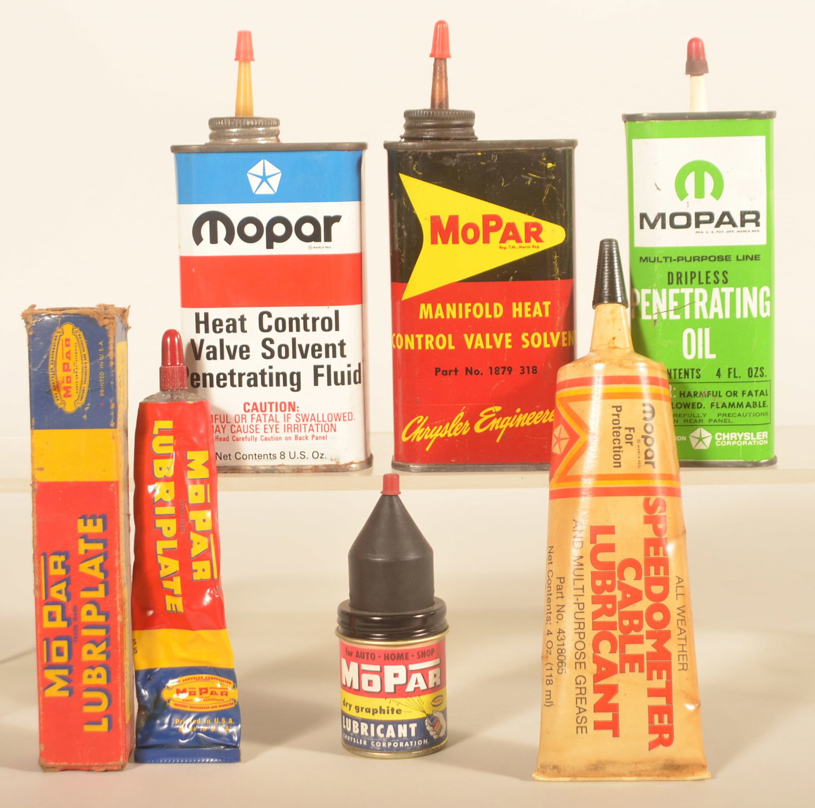 Mopar Handy Oilers & Lubricants: Group of six Mopar containers including two 8 oz. and one 4 oz. oilers. All weather lubricant bottle, older Lubriplate squeeze bottle with original box and dry graphite tin with rubber top. Tallest ca