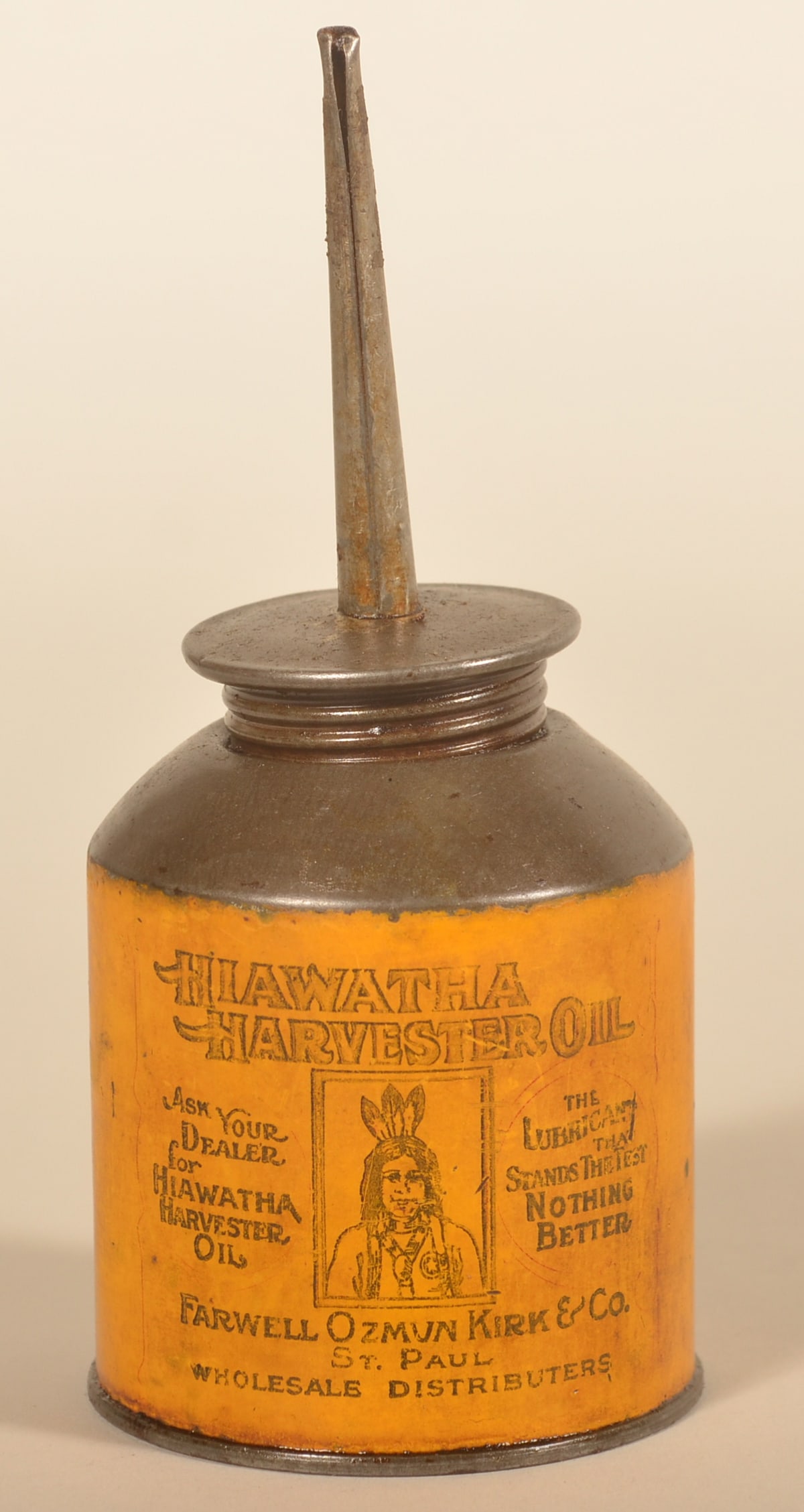 Rare Native American Hiawatha Harvester Oil Can: Made by Farwell, Ozmum Kirk & Co. from St. Paul, Minnesota. Central image featuring a Native American in full regalia, mustard background with black printing. 7"H