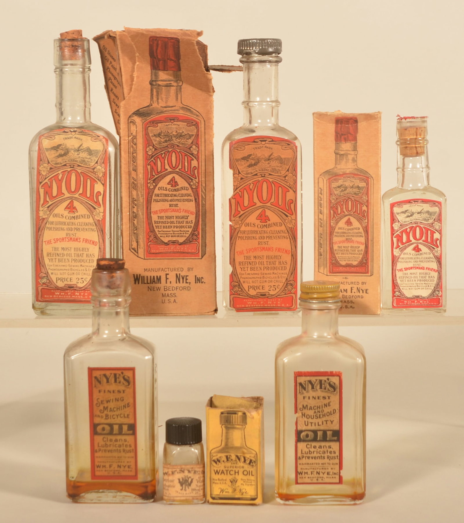 Cork & Screw Top Nye's Machine/Bicycle Oil Bottles: Instant collection of six different size Nye oil bottles from New Bedford, Mass. Three bottles of each kind including an unopened 4 1/2" tall bottle in the original box. Tallest 6 3/4"