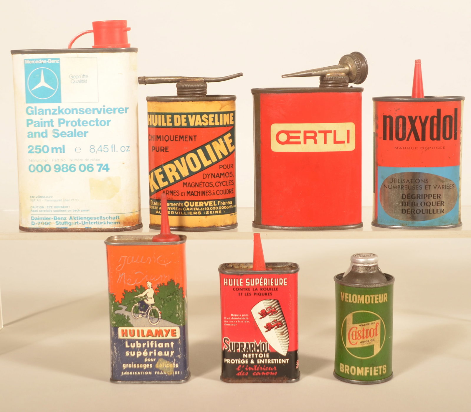 Group Import Handy Oilers Incl. Mercedes-Benz: Seven different cans including Huilamye (featuring hunting, automobile and bicycle graphics), Kervoline, Oertli, Noxydol, Huile Suprarmo, a wonderful size Castrol No. 5 round can in green, and a large
