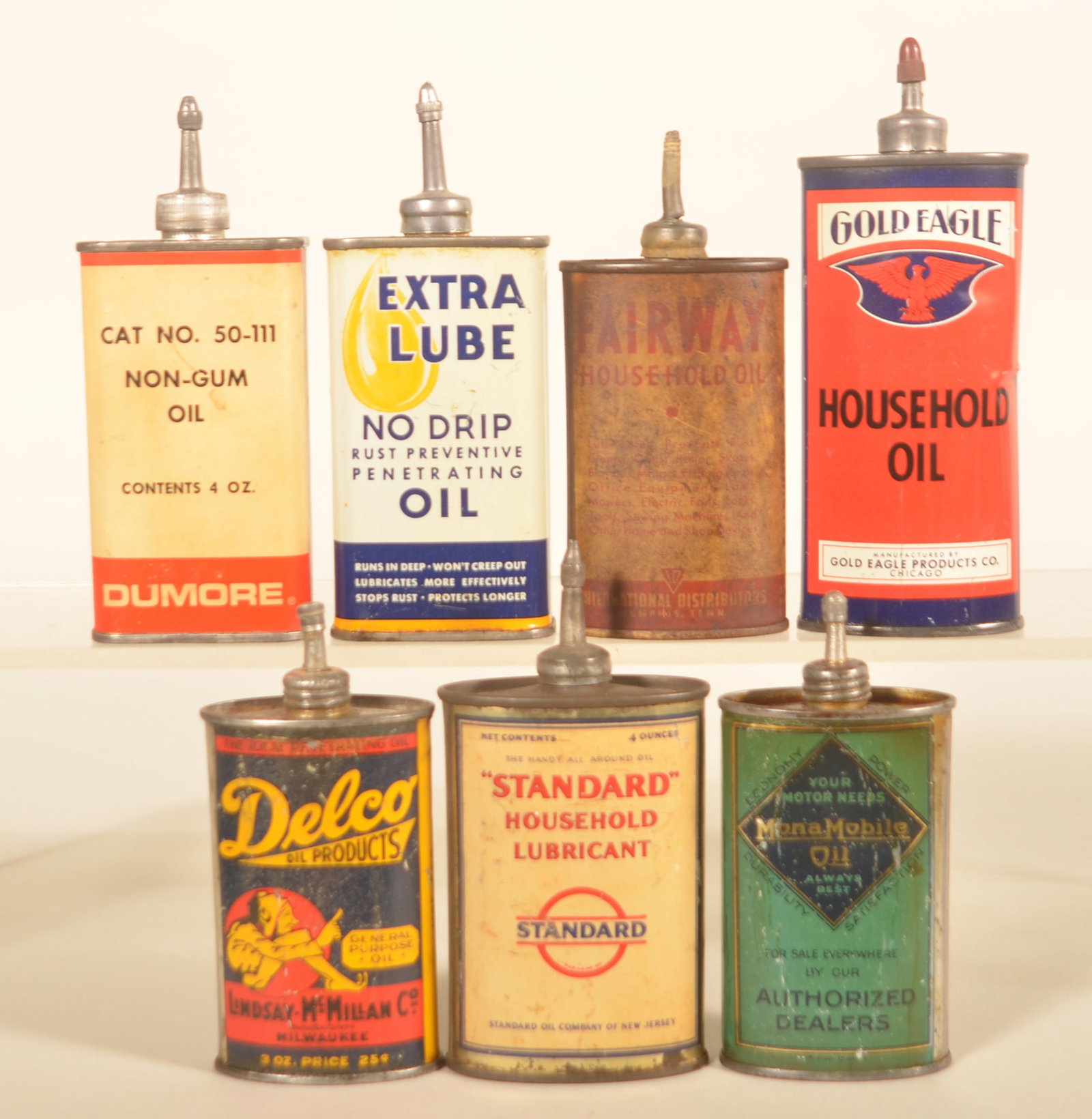 7 Lead Top Handy Oilers Incl. Delco & Gold Eagle: Nice group of older handy oilers. Collection includes Extra Lube, Gold Eagle from Chicago with bright colors, Dumore, rare Delco can from Lindsay-McMillan Co., Standard Oil Company household lubricant